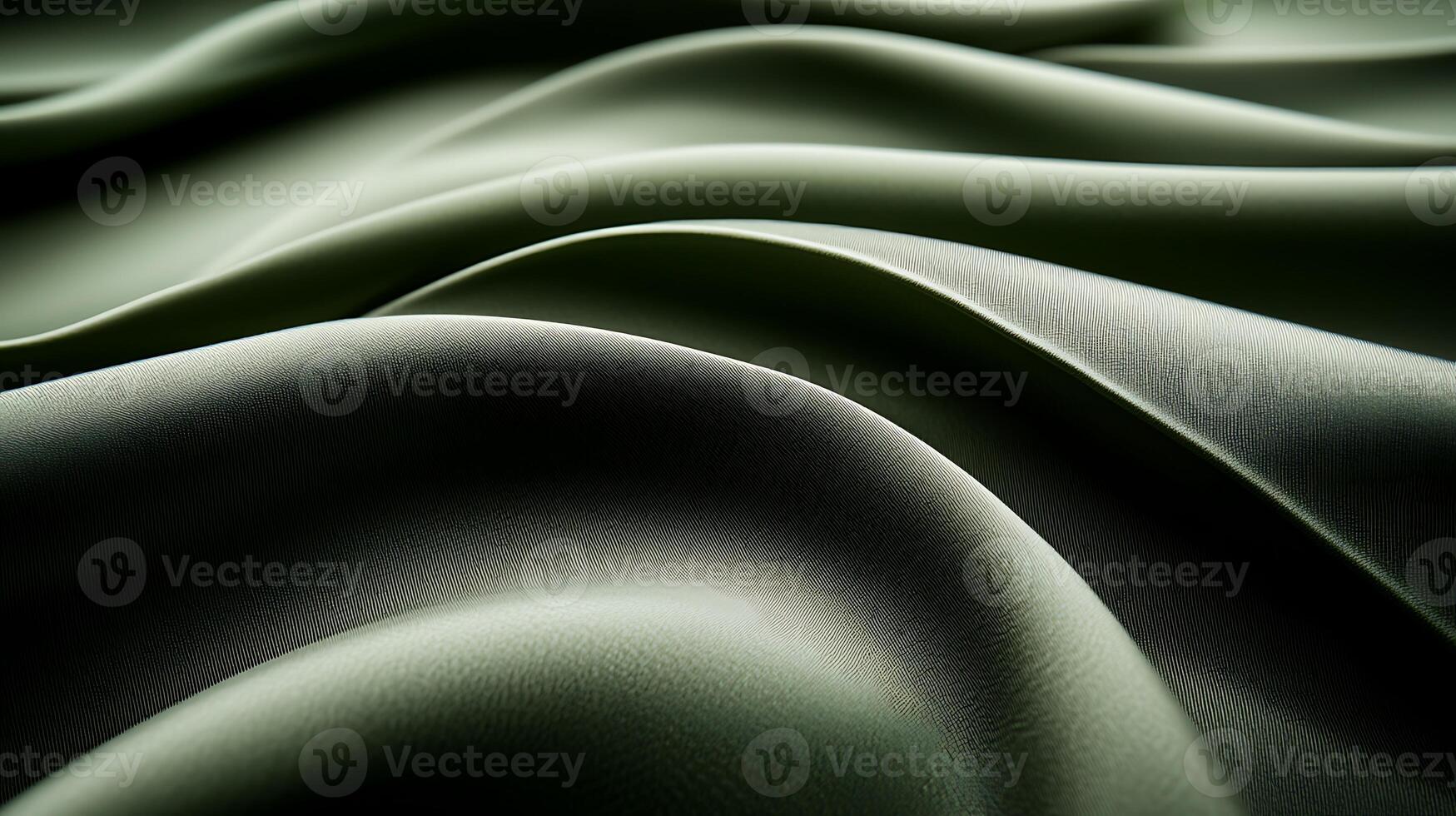 Close-up view of soft, flowing green fabric draped elegantly, showcasing texture and depth photo