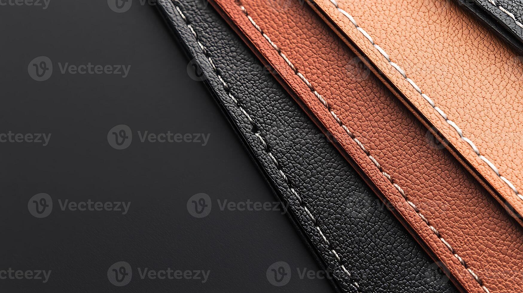 Close-up view of textured leather strips in black, brown, and beige arranged on a dark background photo
