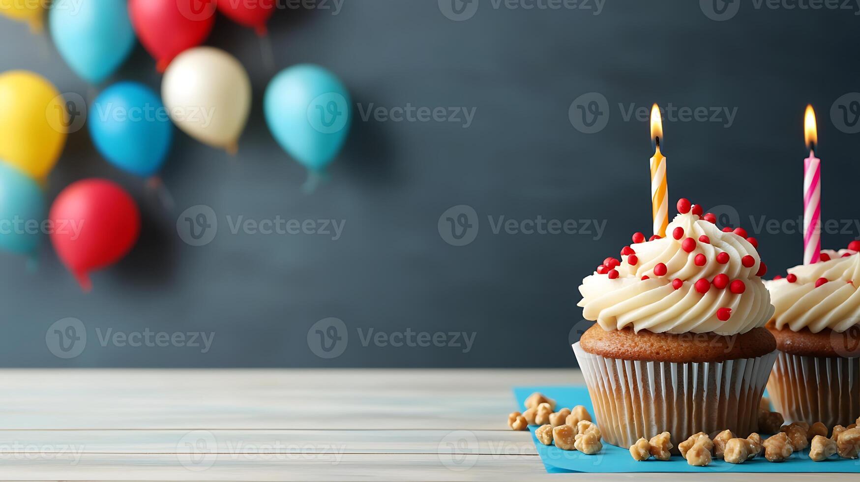 Colorful birthday cupcakes with candles on a table, festive balloons in the background photo