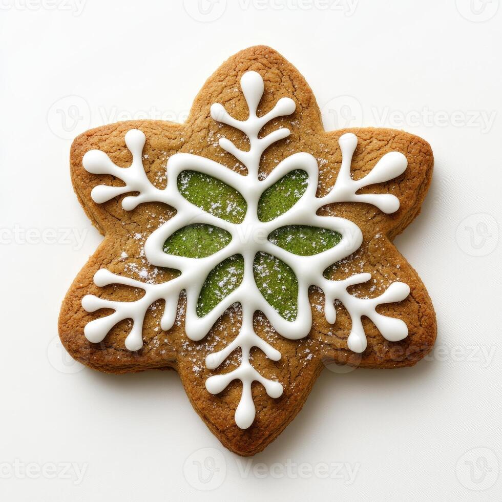 A decorative star-shaped gingerbread cookie, intricately iced with a green snowflake design photo