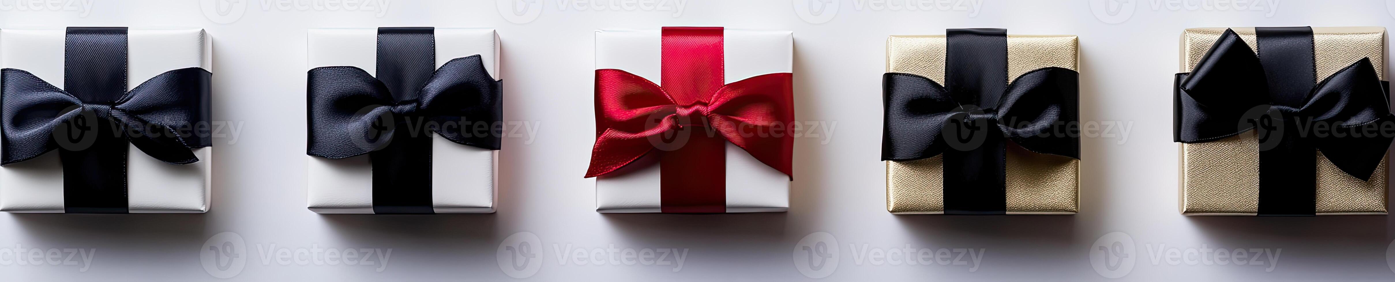 Four gift boxes with black, red and white bows photo