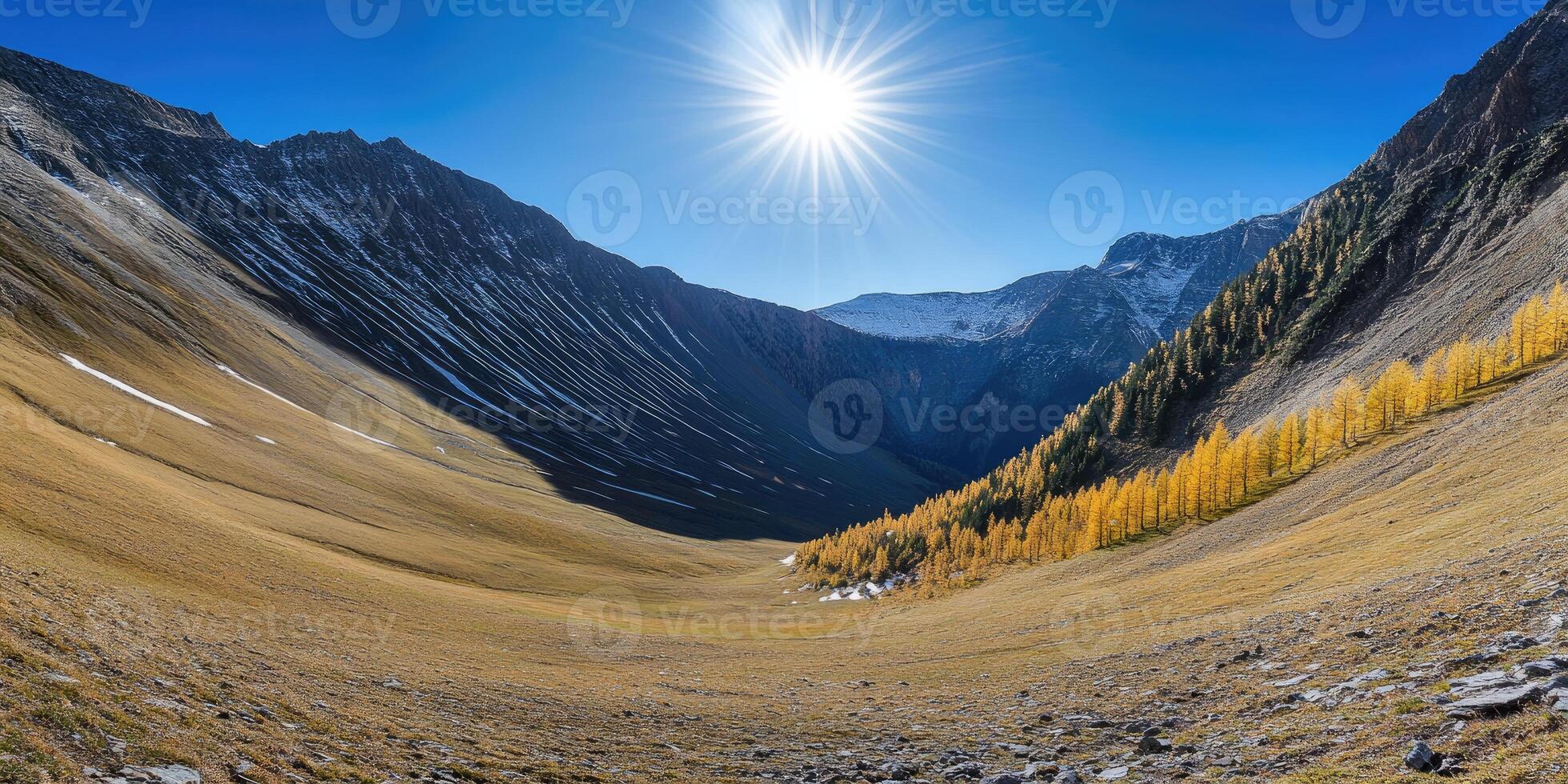 A view of a mountain valley with yellow trees photo