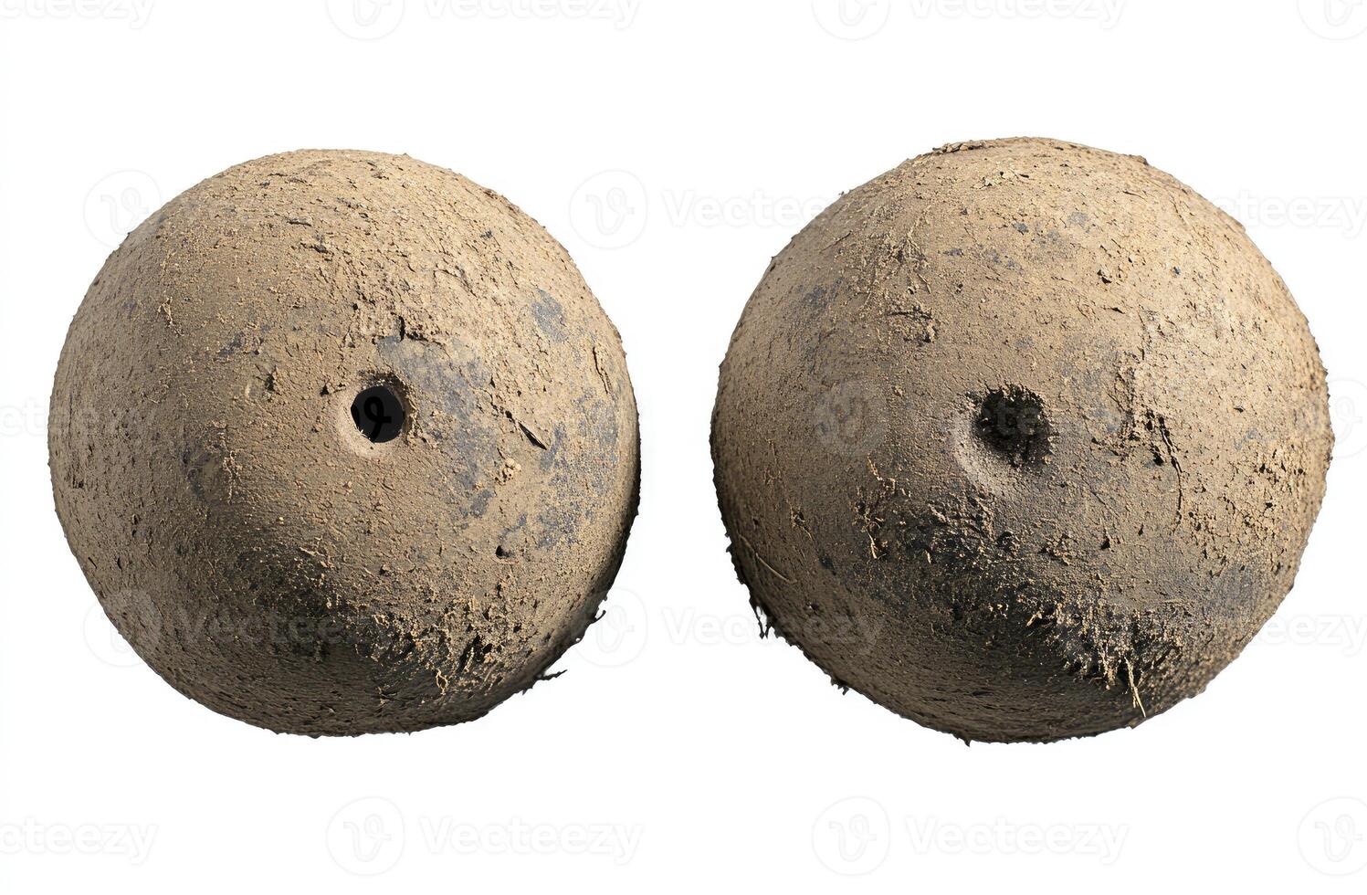 Two ancient, dirty, round, clay balls, likely game pieces or projectiles photo