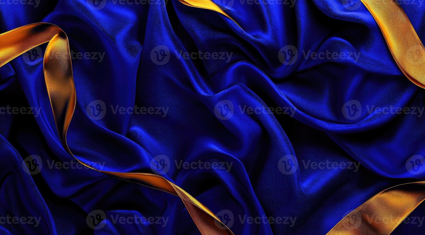 Luxurious deep blue silk draped with golden ribbons photo