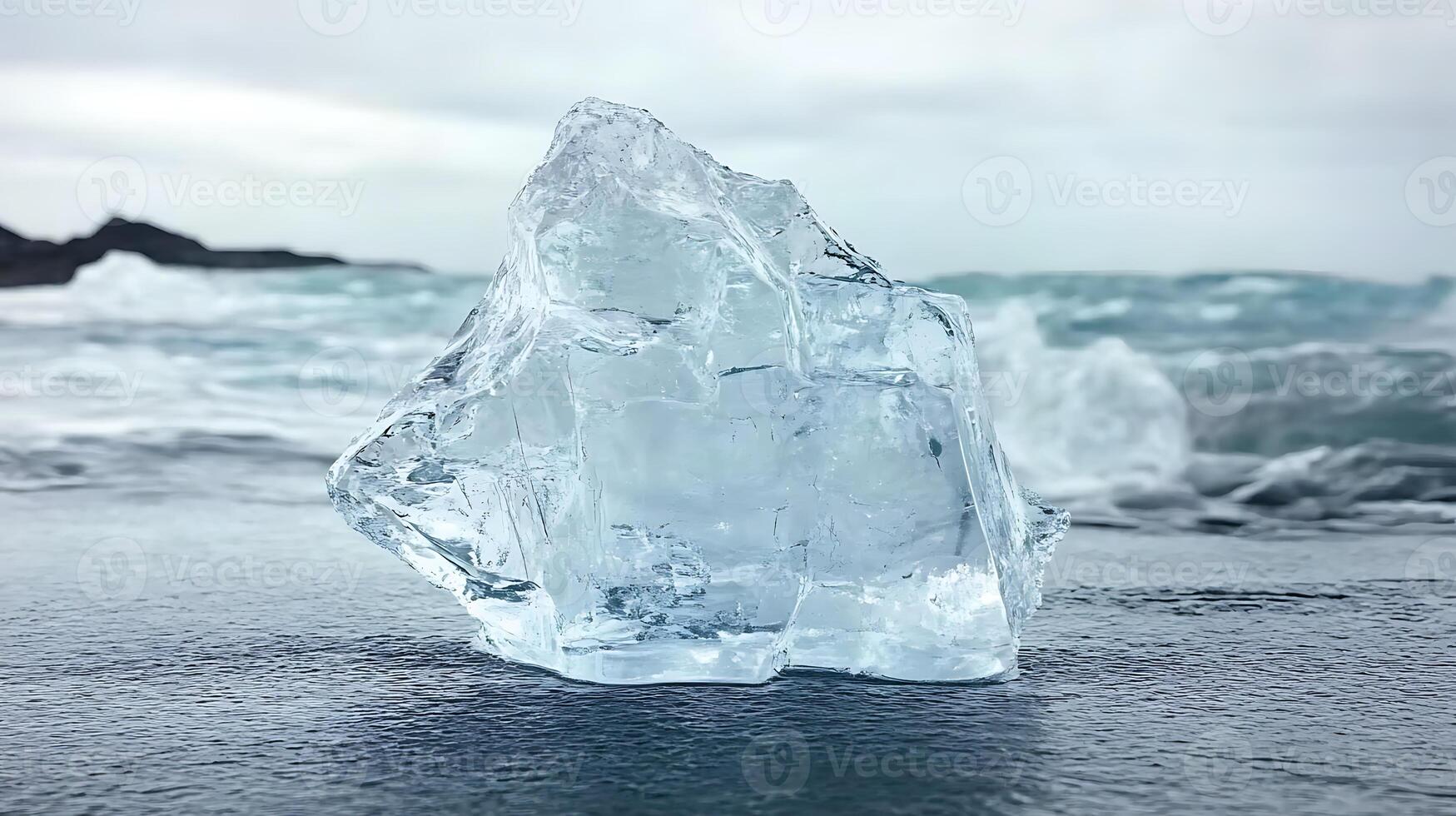 Crystal Iceberg on Black Sand Beach with Ocean Waves in Background photo