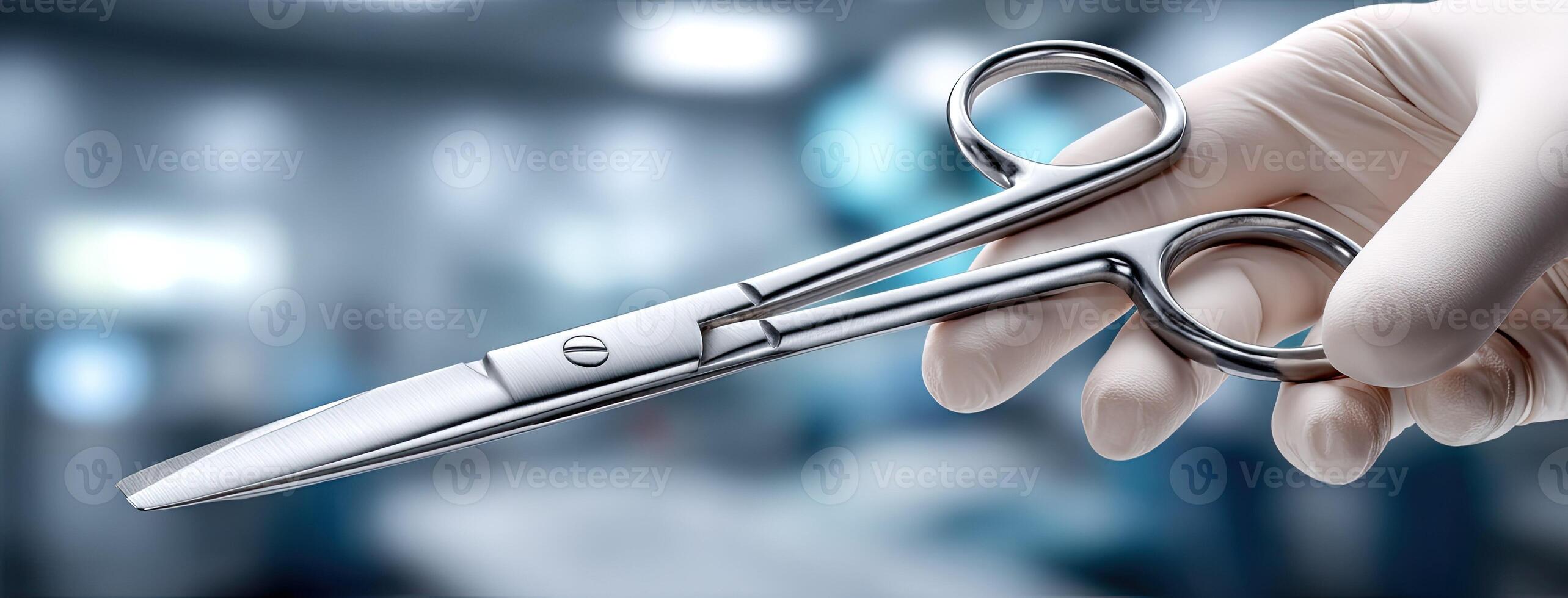 A person holding a pair of surgical scissors photo