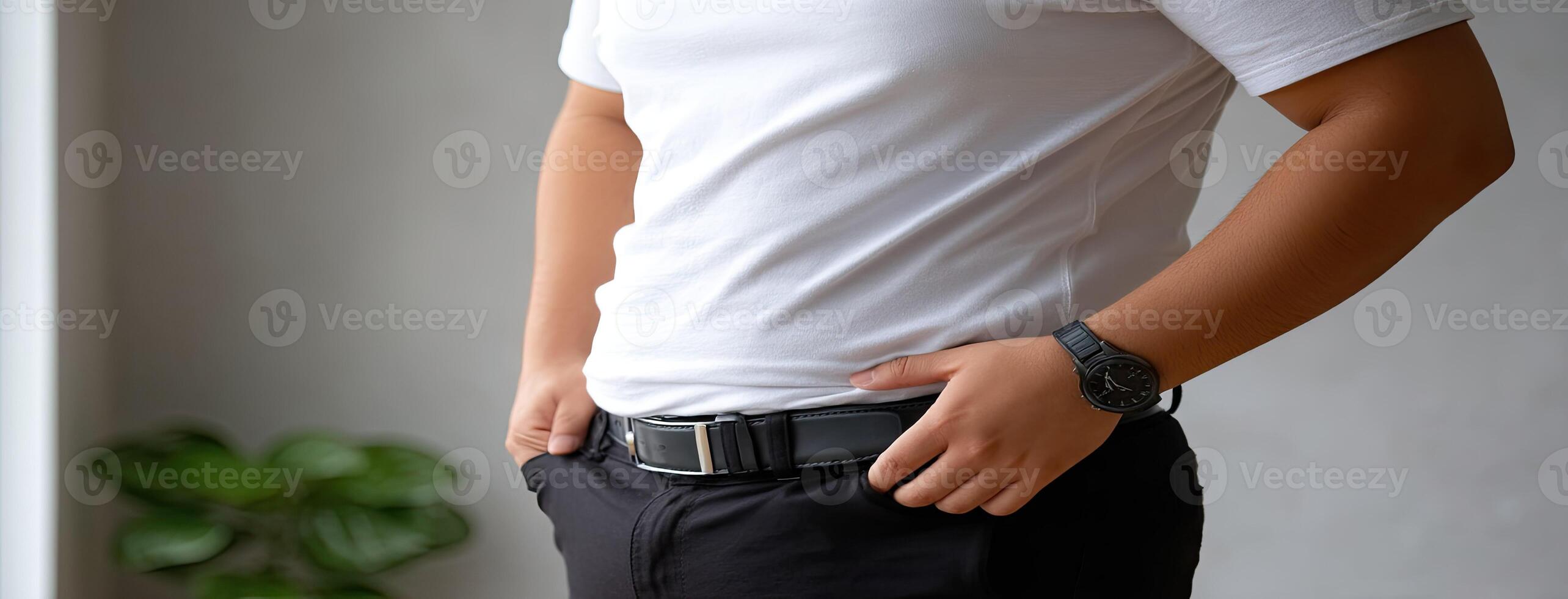 A man in a white shirt and black belt photo