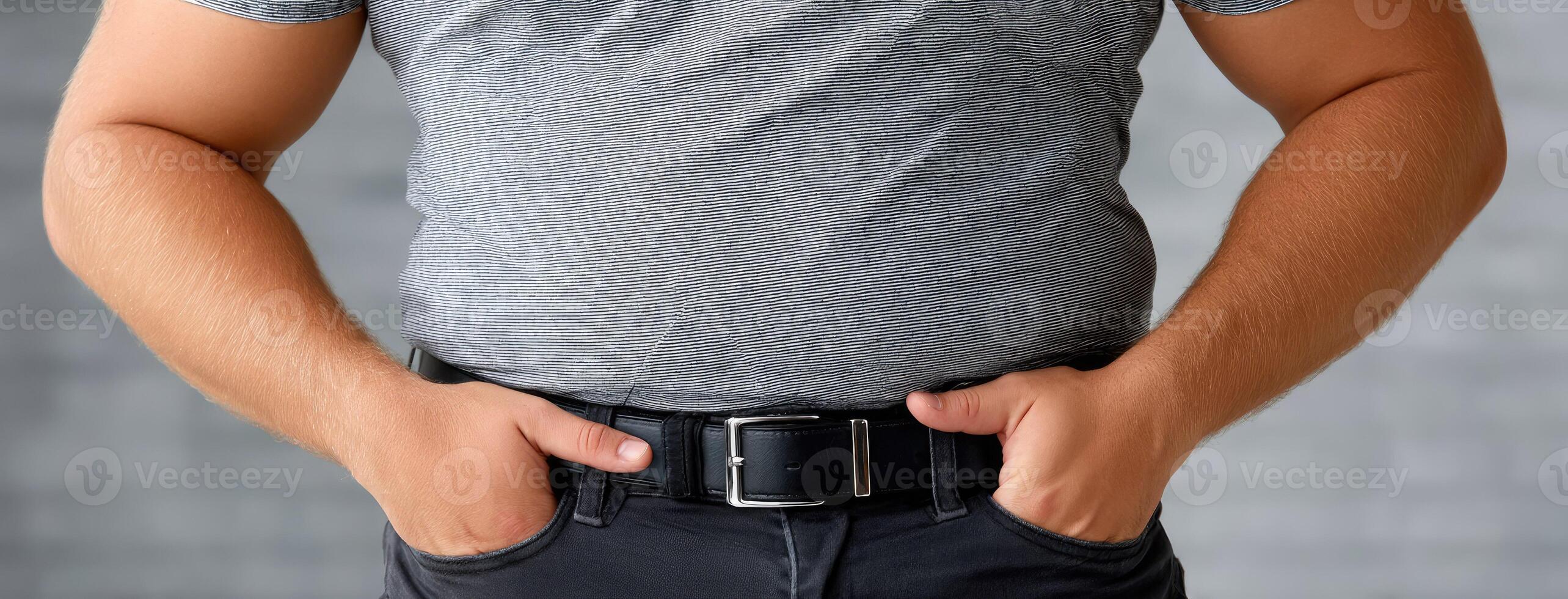 A man in a gray shirt and black belt photo
