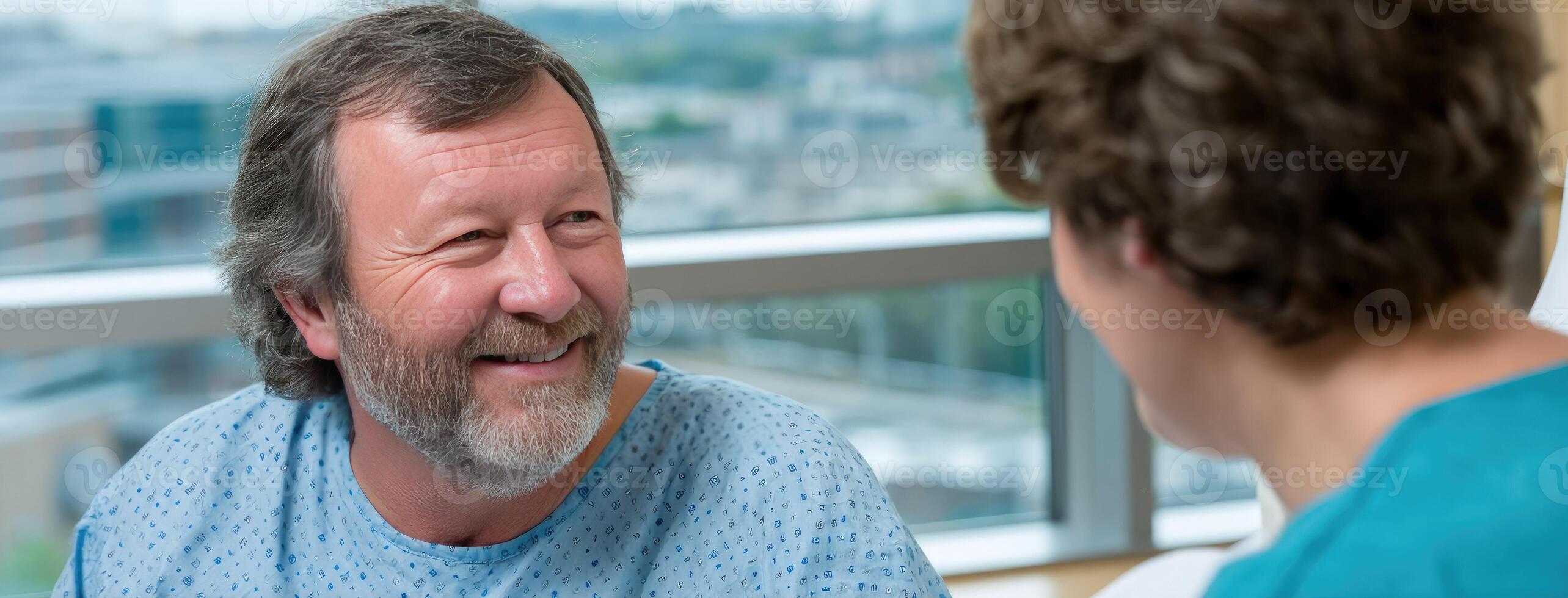 A man in a hospital room talking to another man photo