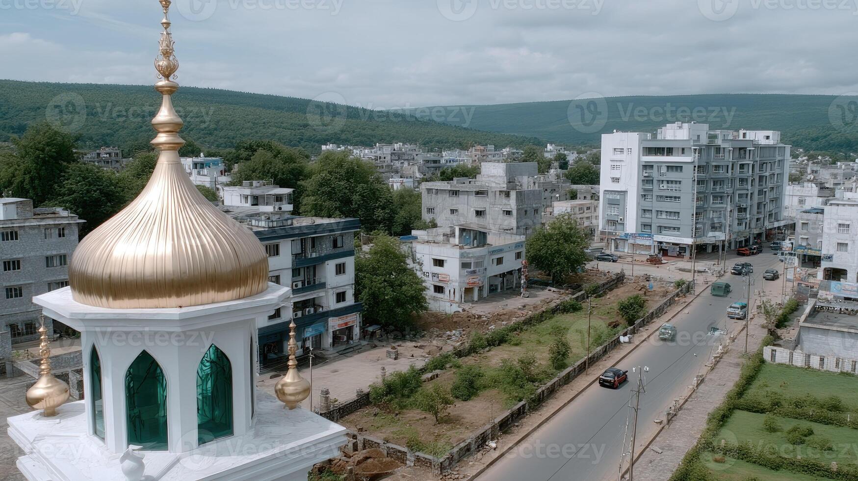 A white mosque with a gold dome in the middle of a town photo
