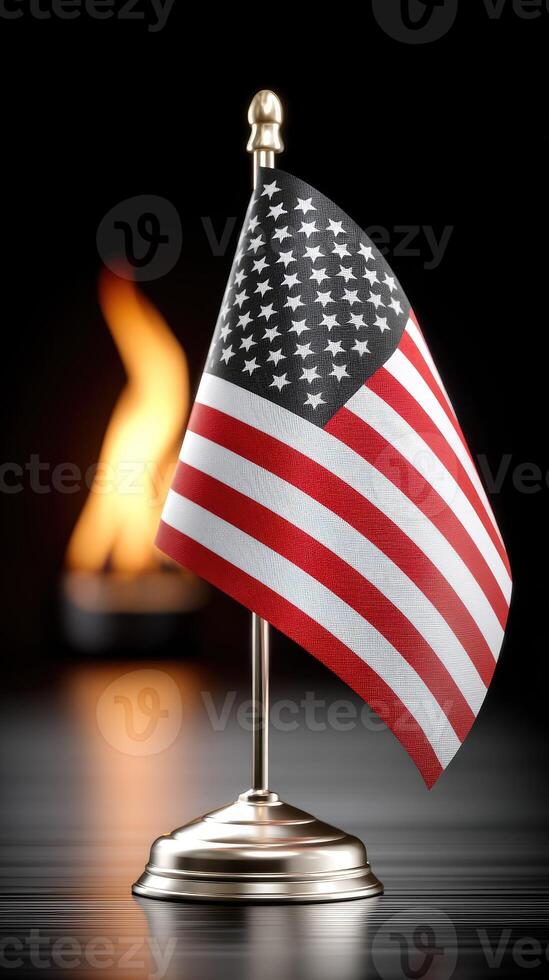 American flag on a metal stand with a flame in the background photo