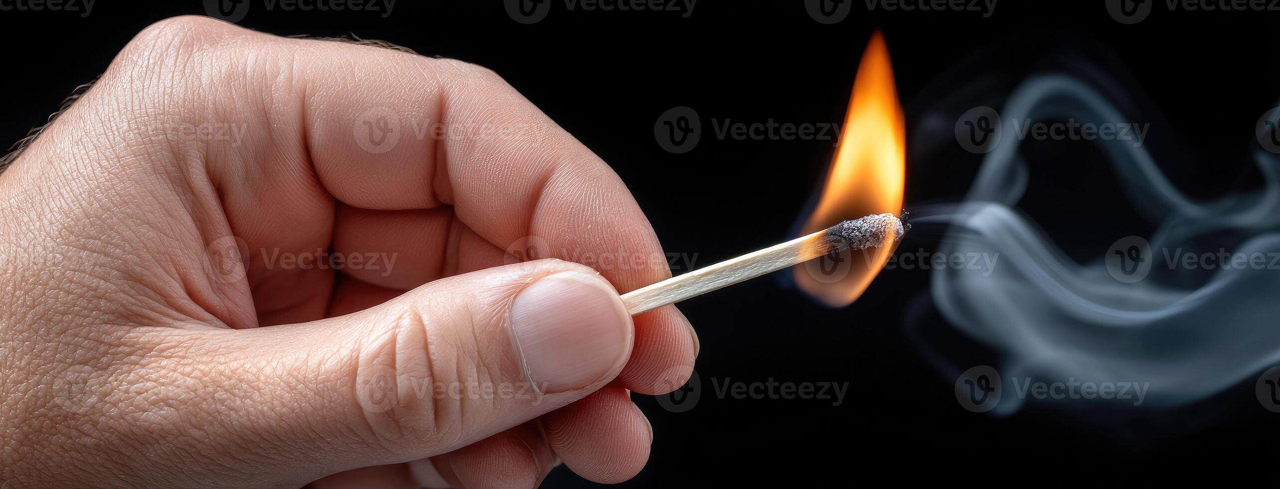 A person holding a matchstick with a match on it photo