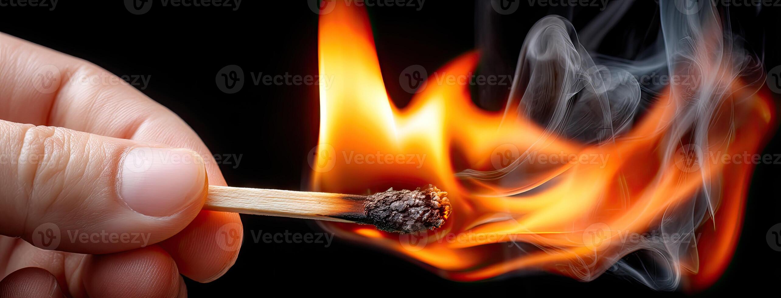 A person holding a matchstick with a match on fire photo