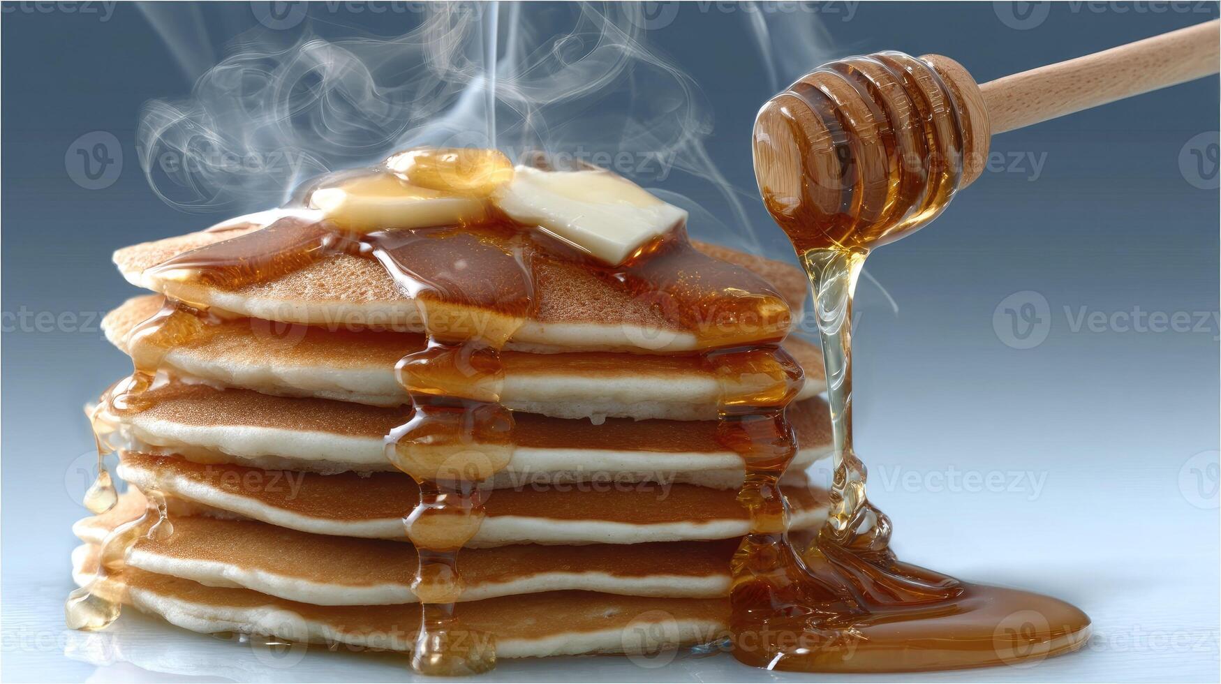 A stack of pancakes with syrup and honey drizzled on top photo