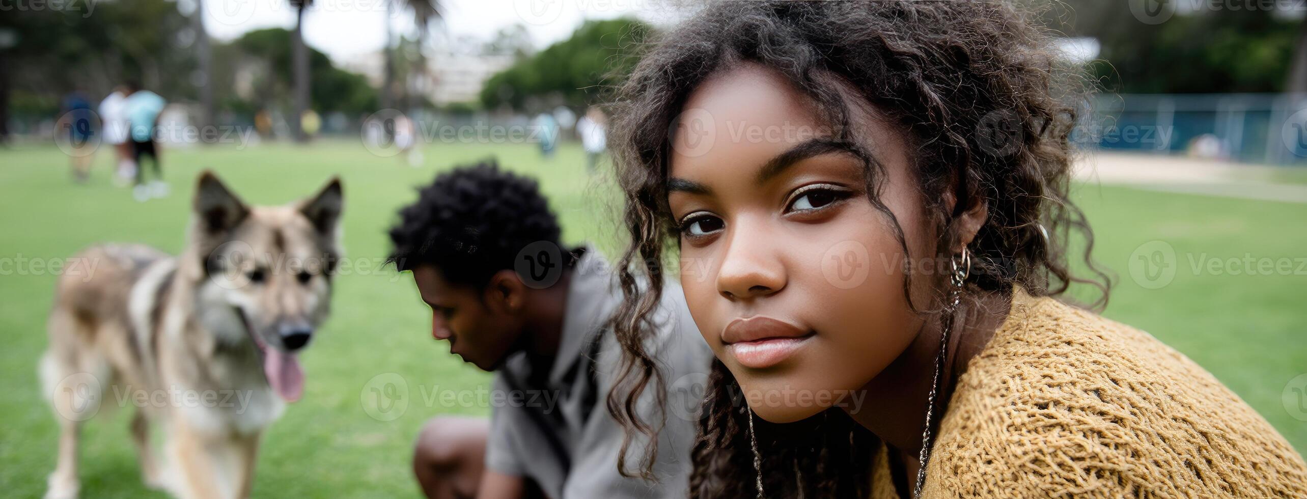 A young girl is sitting on the grass with two dogs photo