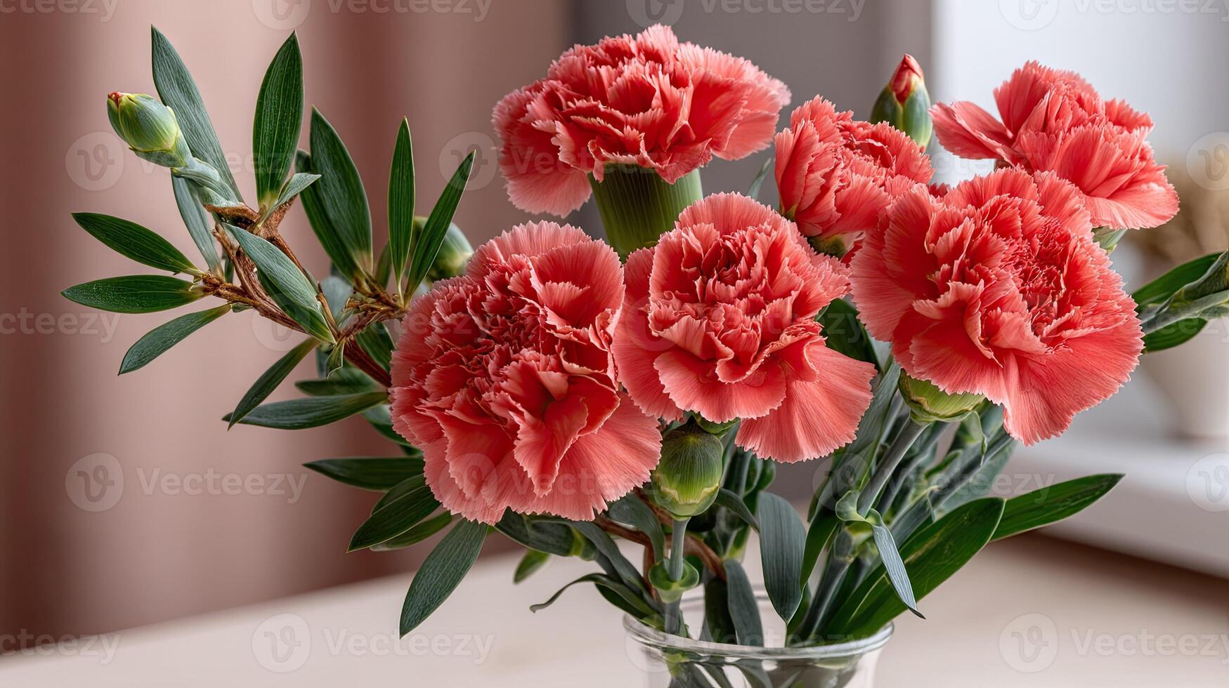 A vase filled with pink carnations on a table photo