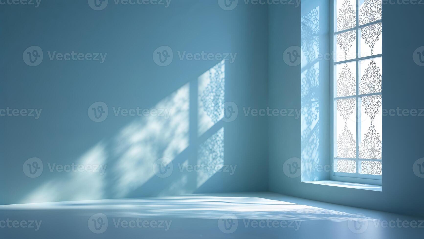 Beautiful light patterns cast by an intricate window design in a serene blue room during daytime photo