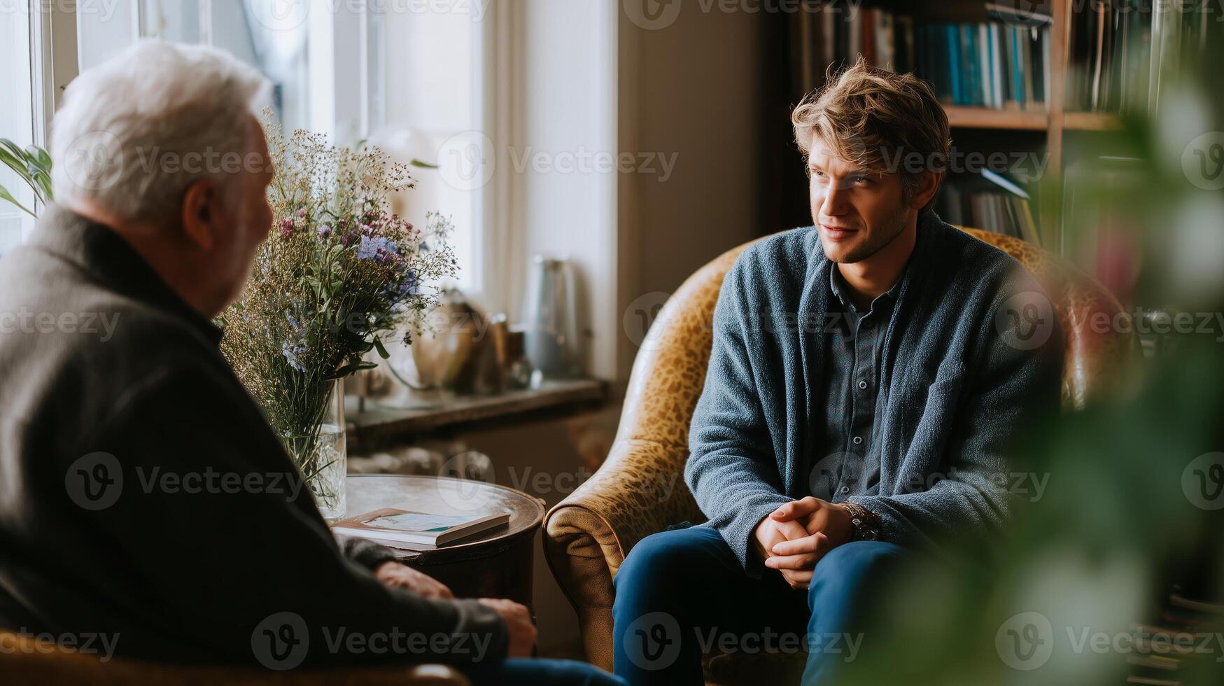Two men engage in a meaningful conversation in a cozy cafe setting during a sunny afternoon photo