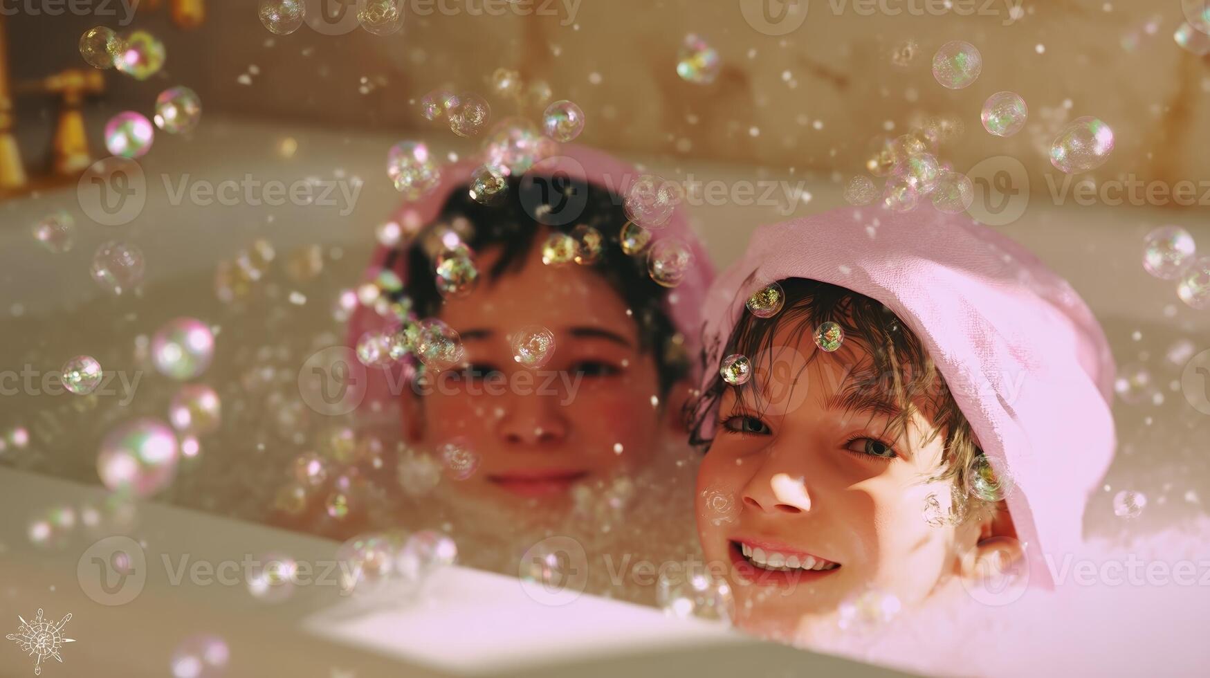 Two children enjoy a playful bubble bath together wearing pink towels in a cozy bathroom setting with warm lighting photo