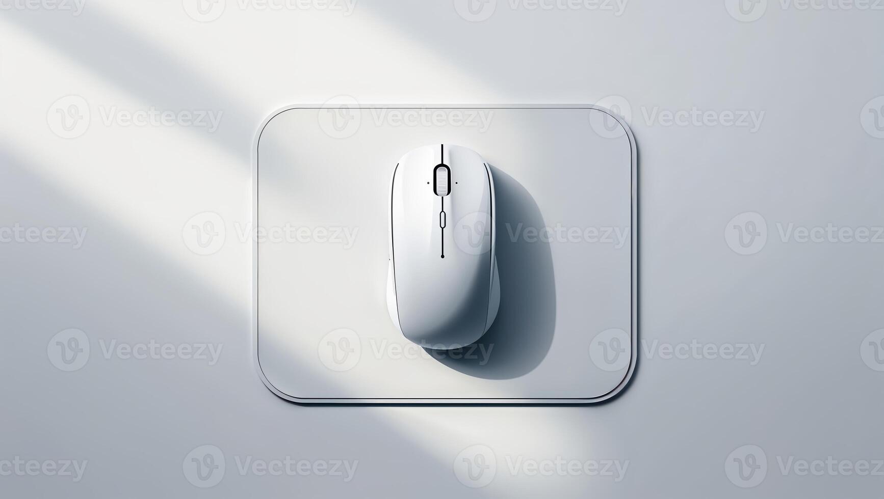 Minimalist white computer mouse on a grey surface illuminated by soft natural light in an indoor setting photo