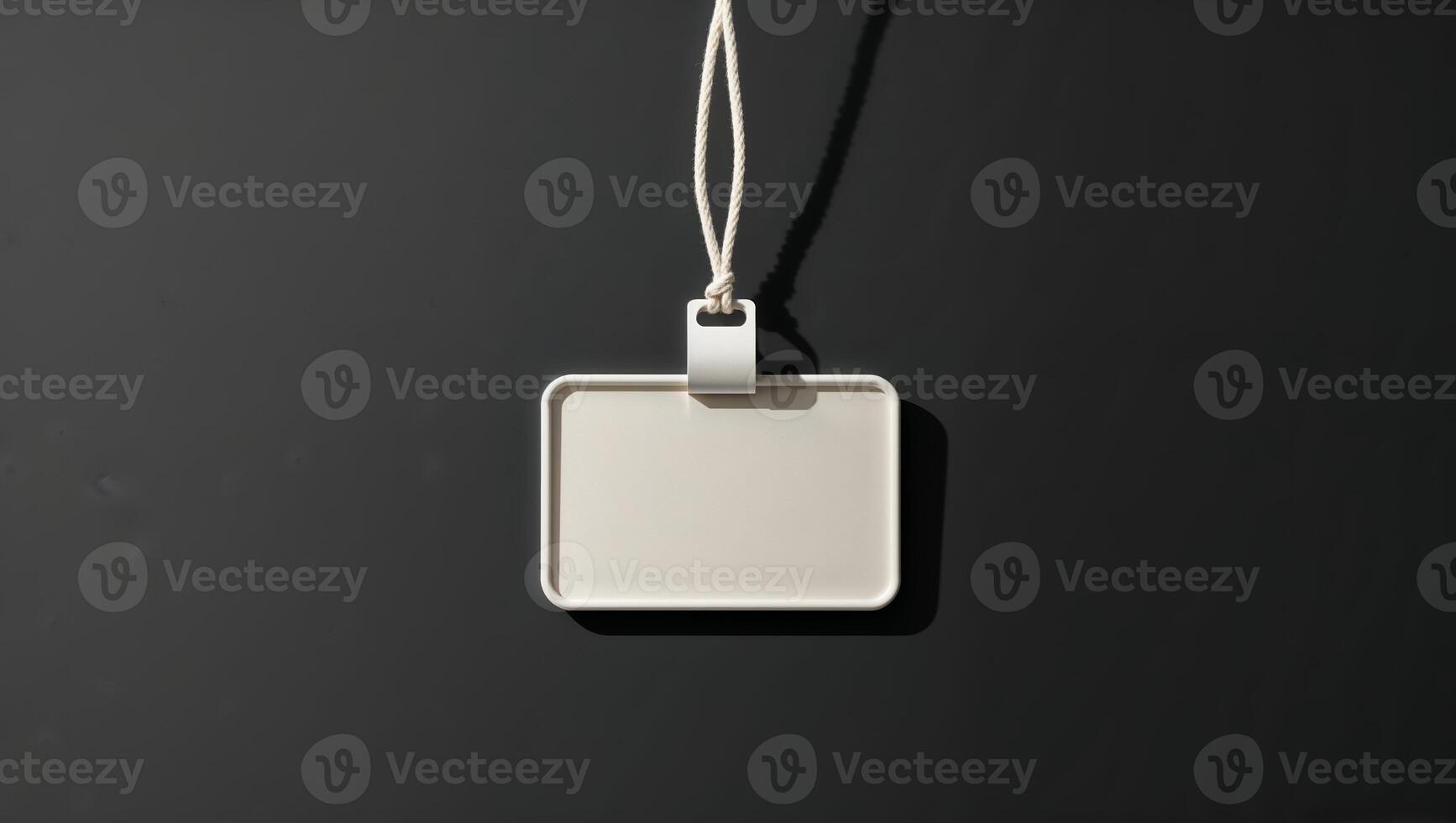 Blank rectangular tag placed on a dark background showcasing its simple design and potential for customization options photo