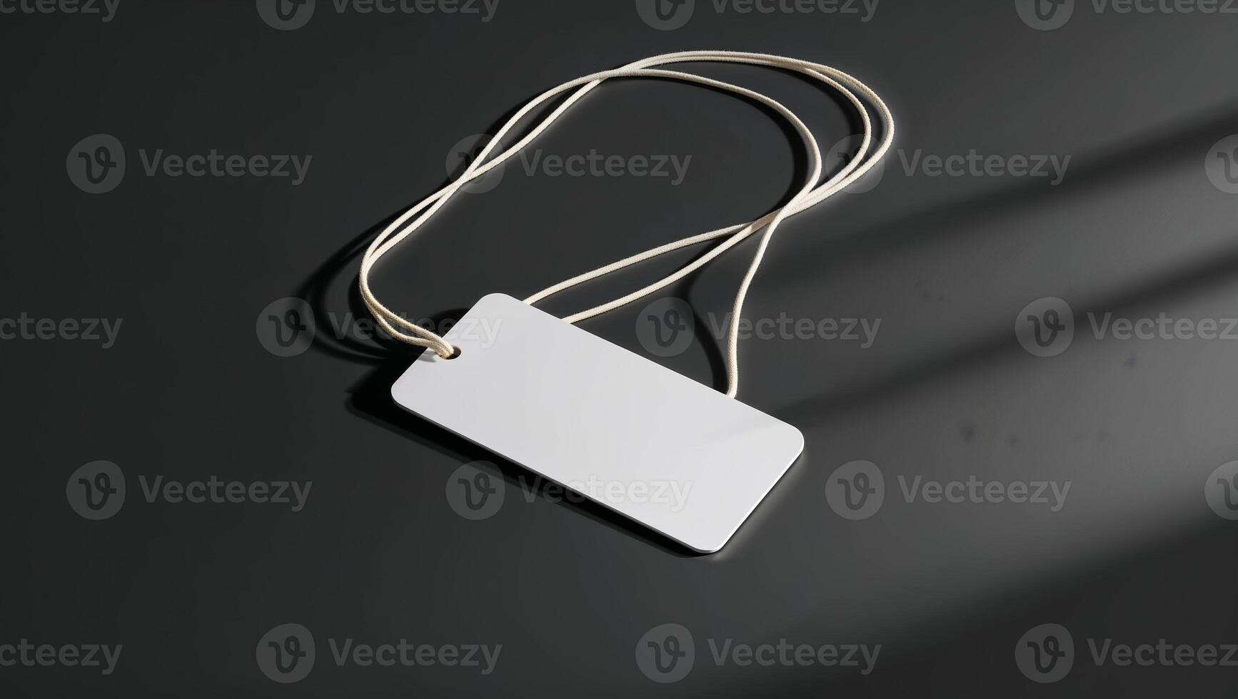 Blank tag hanging on a string with a minimalist design on a dark surface photo
