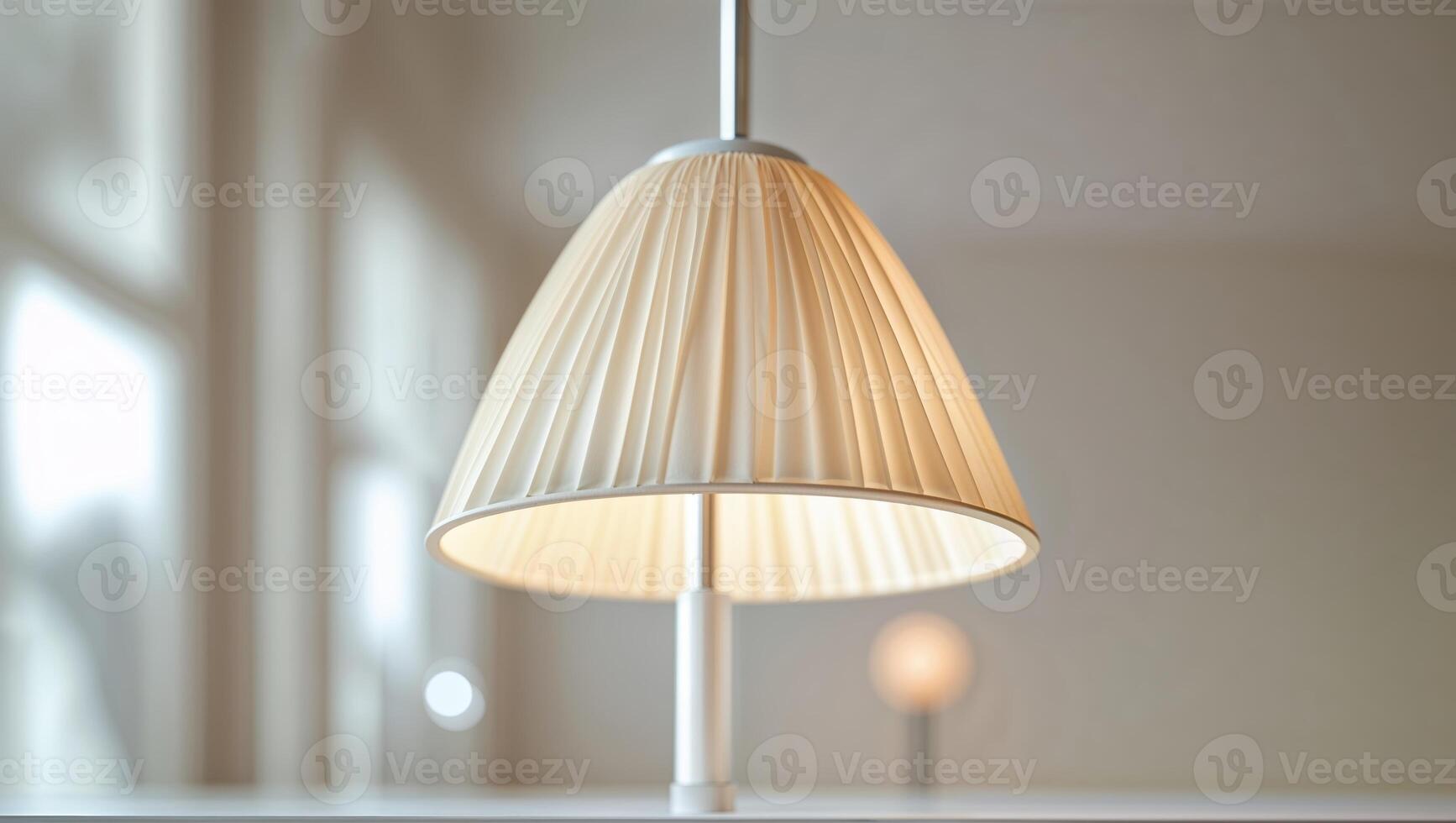 Modern hanging lamp illuminates indoor space with soft light in a stylish, minimalist setting during daytime photo