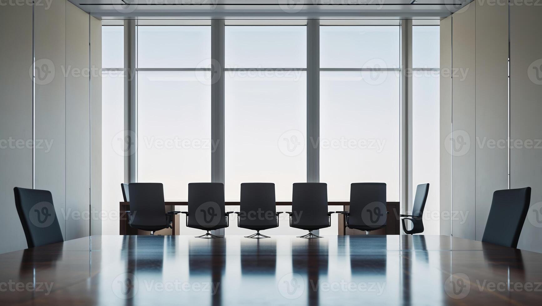 Conference room setup with modern furniture and large windows providing natural light during midday photo