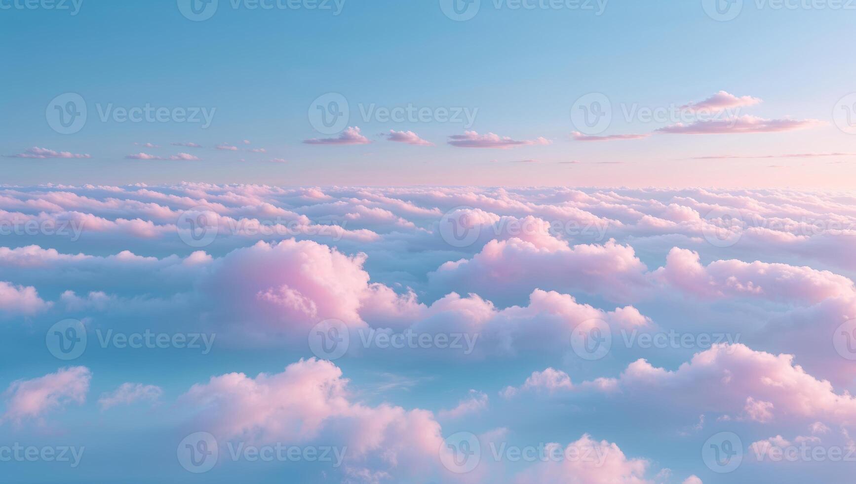 Serene pastel clouds stretch across the sky during sunset above a tranquil landscape photo