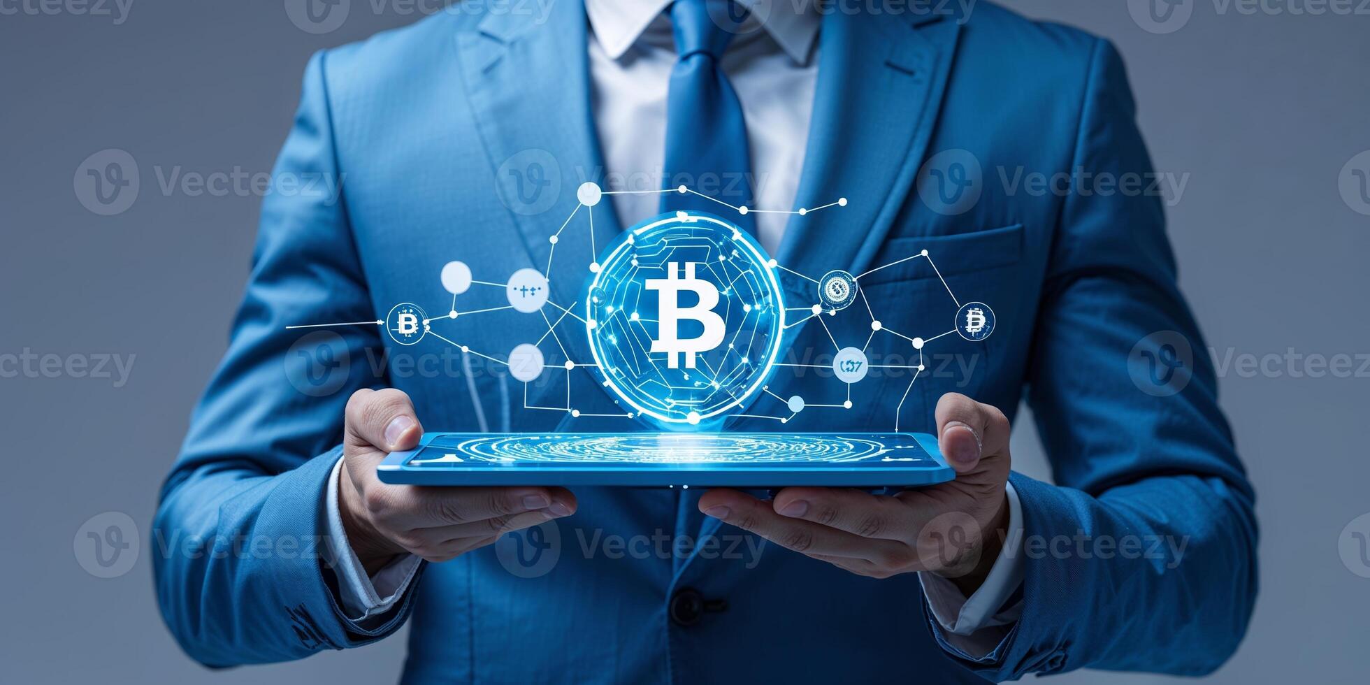 Businessman in blue suit holds tablet displaying Bitcoin cryptocurrency network concept with digital connections photo