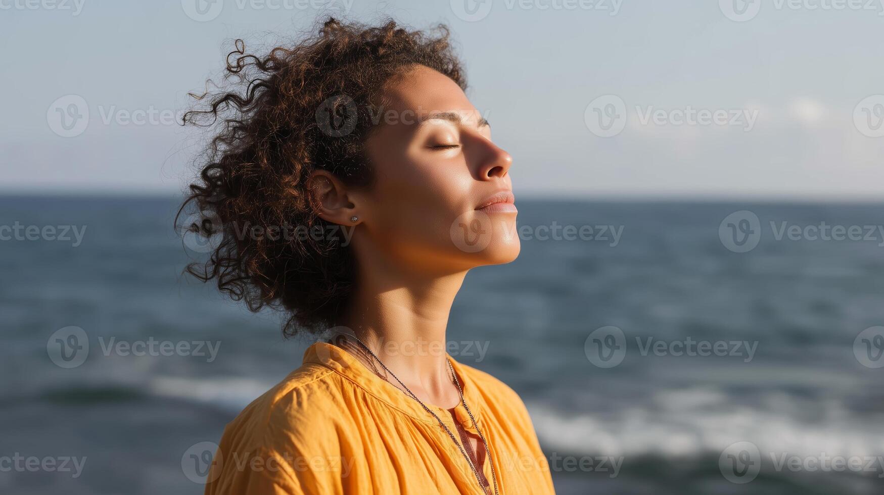 Woman enjoying peaceful moment at seaside during sunset while practicing mindfulness and relaxation techniques photo
