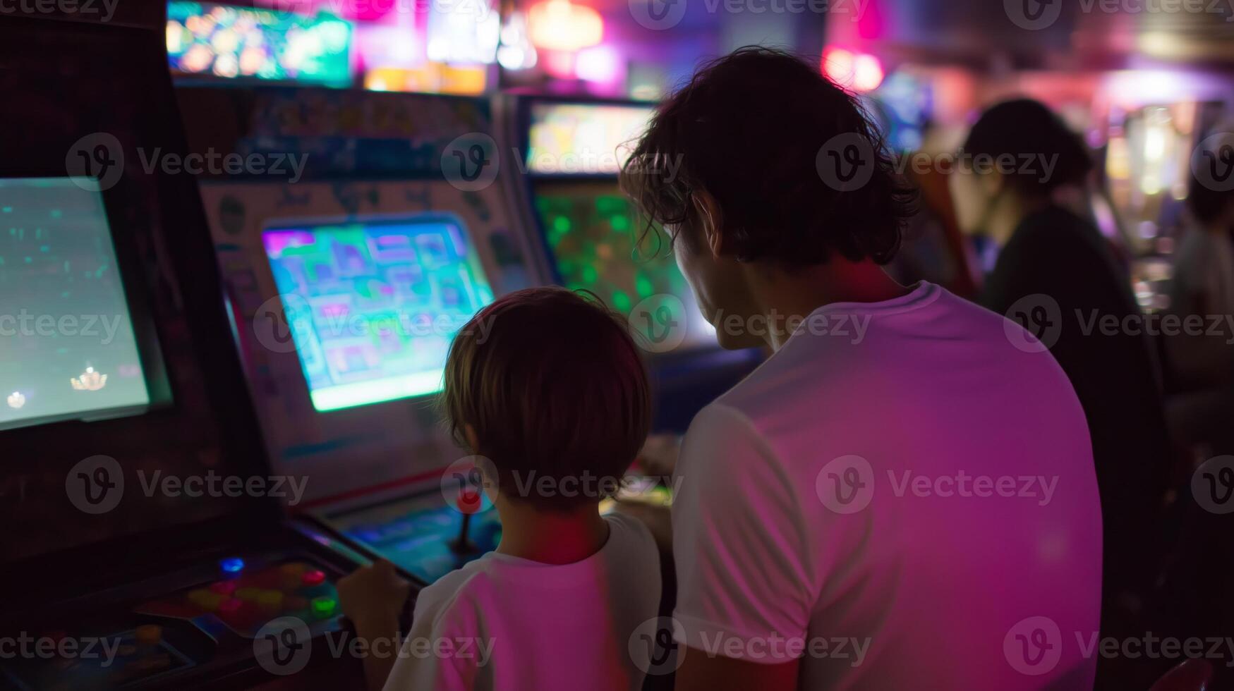 Father and son enjoy a fun gaming experience at an arcade filled with vibrant lights in the evening photo