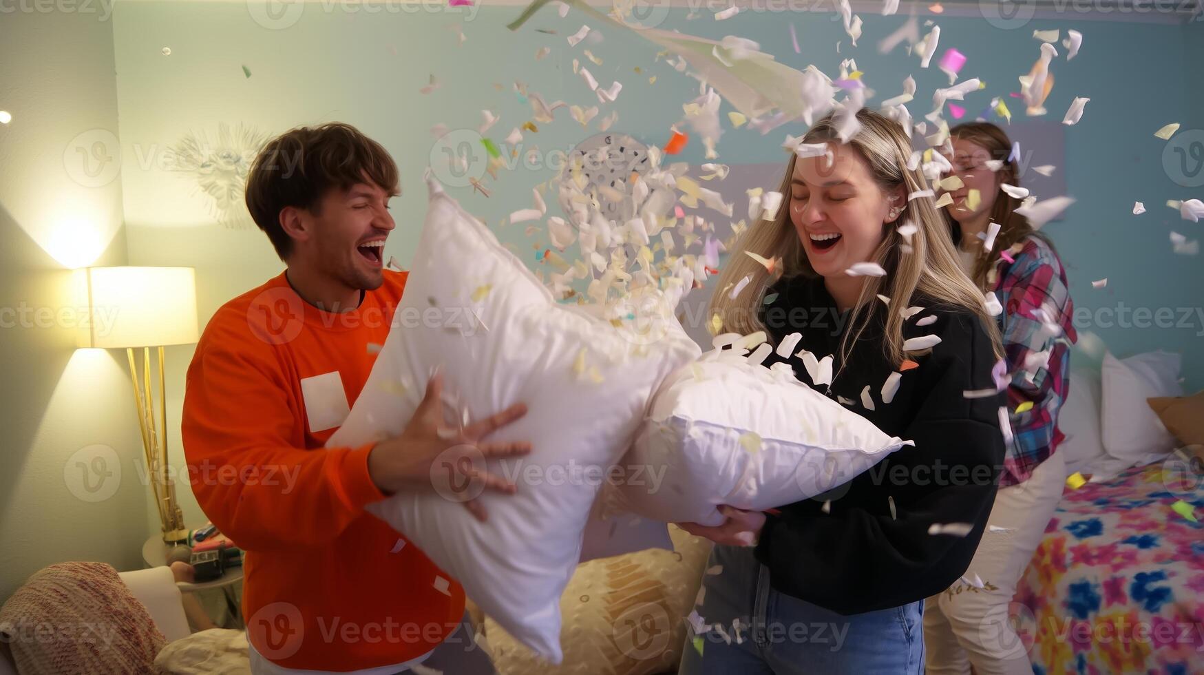 Friends enjoying a lively pillow fight indoors during a cozy gathering in a cheerful bedroom photo