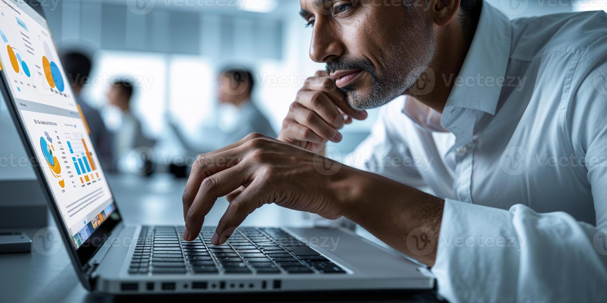 Man analyzes data on laptop screen in modern office environment during daytime meeting session photo