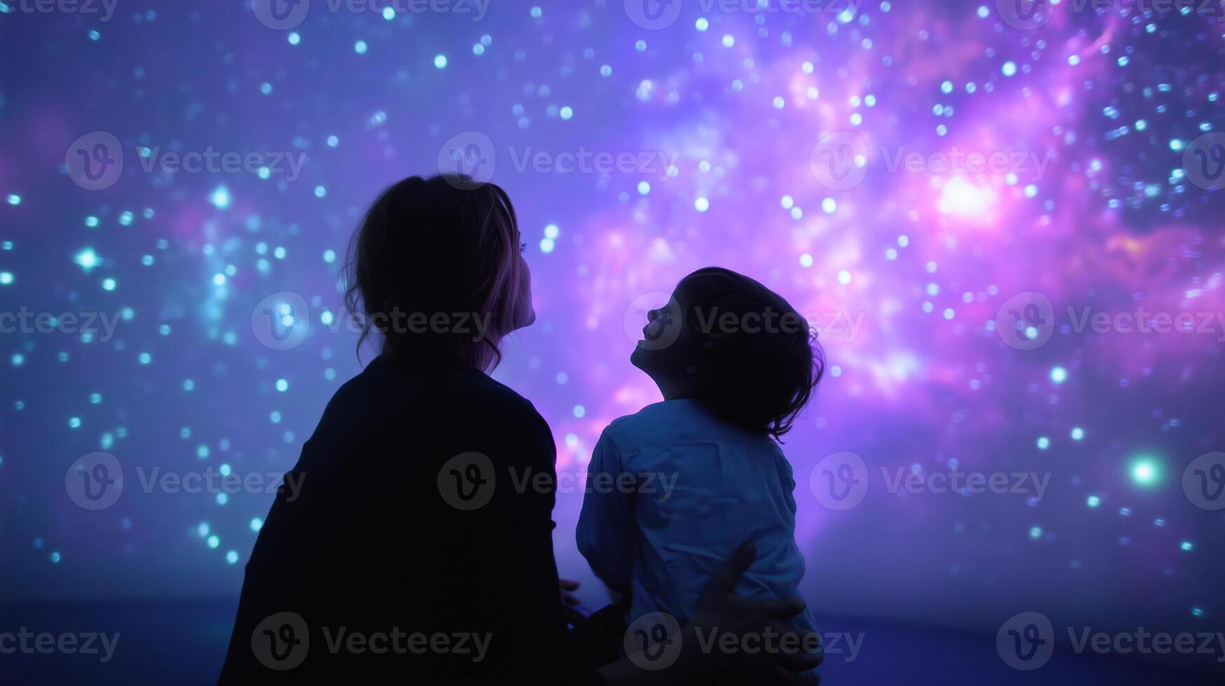 Viewing a colorful galaxy projection together at an interactive art exhibit during the evening photo