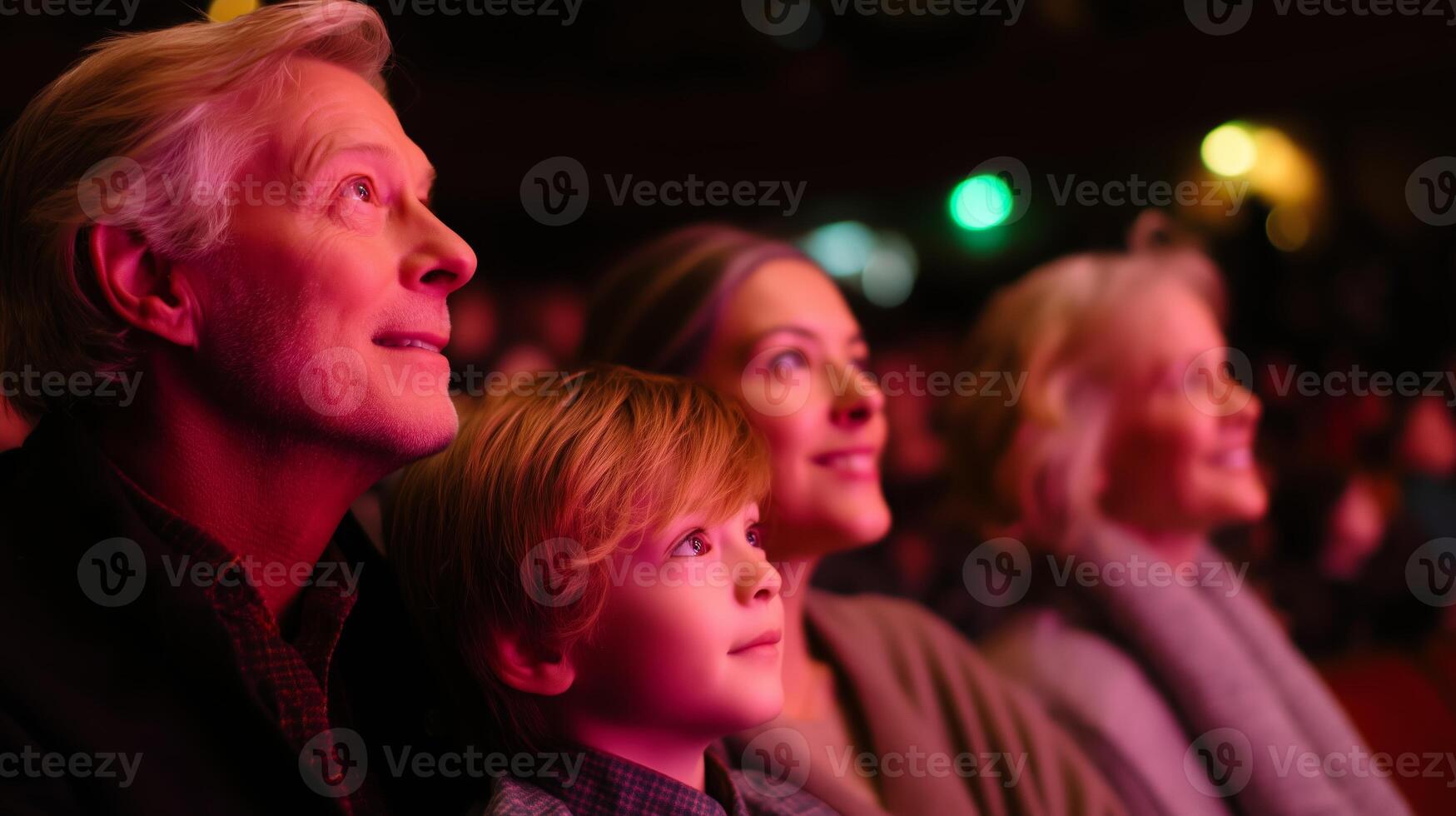 Family enjoys a captivating performance at a theater in the evening photo