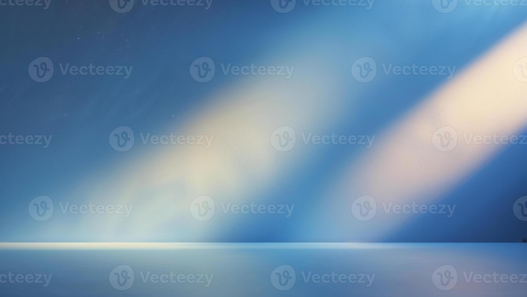 Soft rays of light illuminate a tranquil, blue-toned space during the early morning hours photo