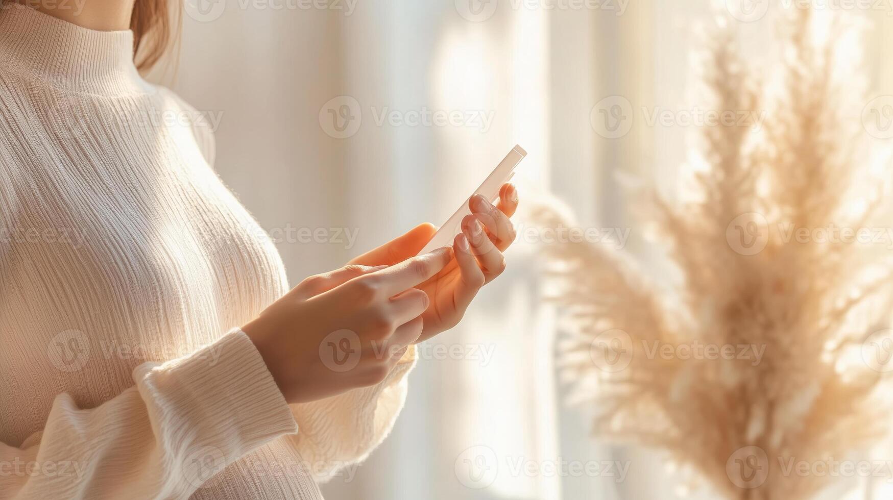 Woman holding smartphone in warm indoor setting with natural light filtering through curtains during daytime photo