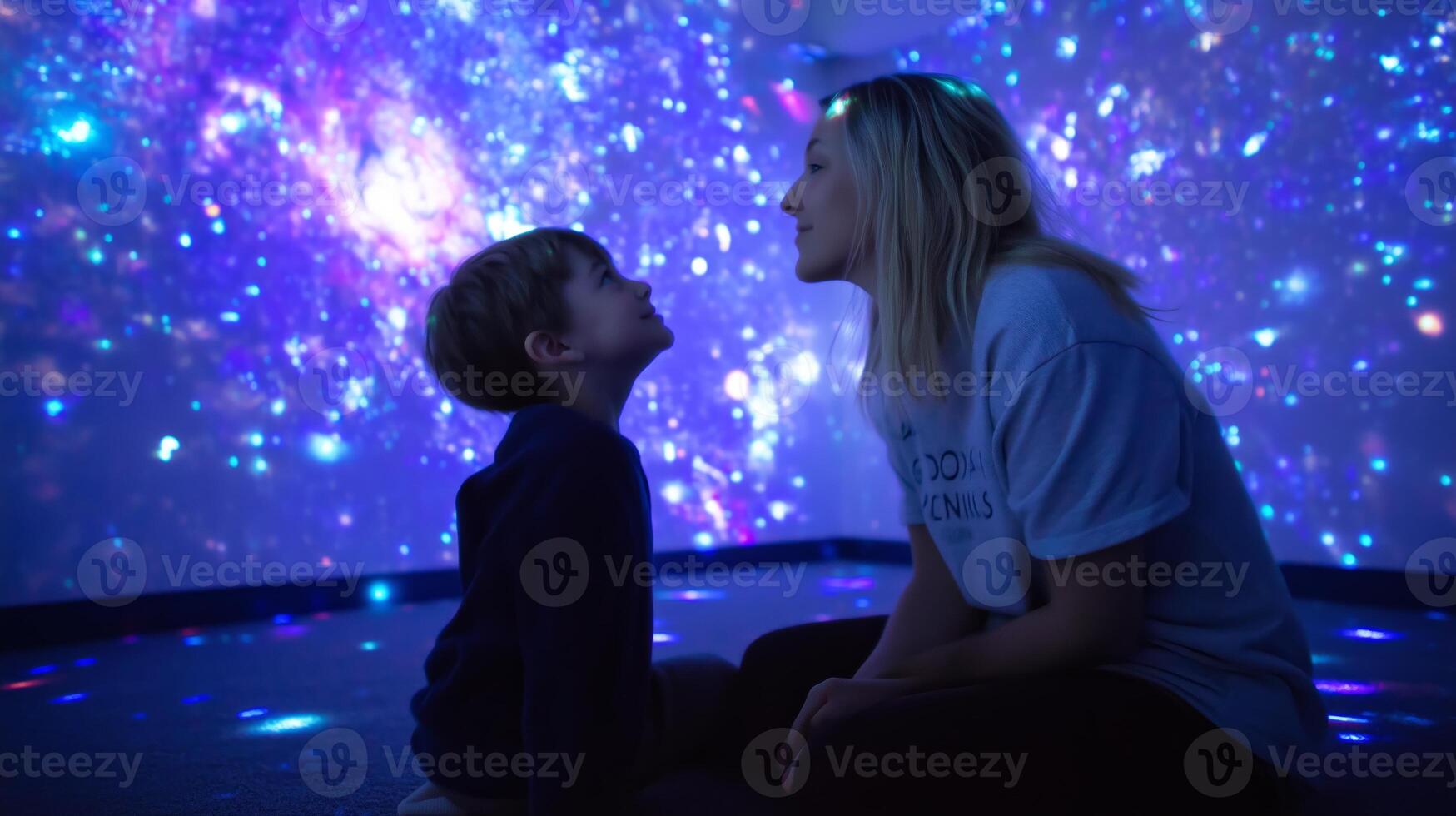 Mother and son enjoy engaging moments in a cosmic-themed room while exploring space concepts photo
