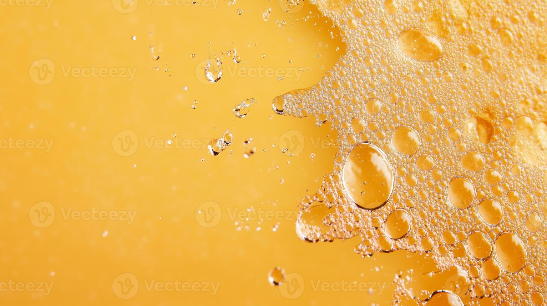 Bubbles and droplets dance on a golden liquid surface in a refreshing beverage photo