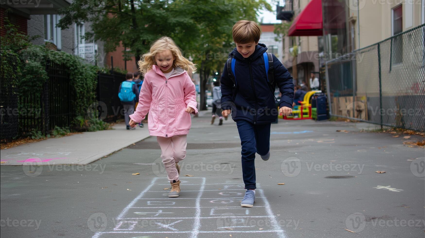 Children play hopscotch on a city street during a cloudy afternoon in an urban neighborhood photo