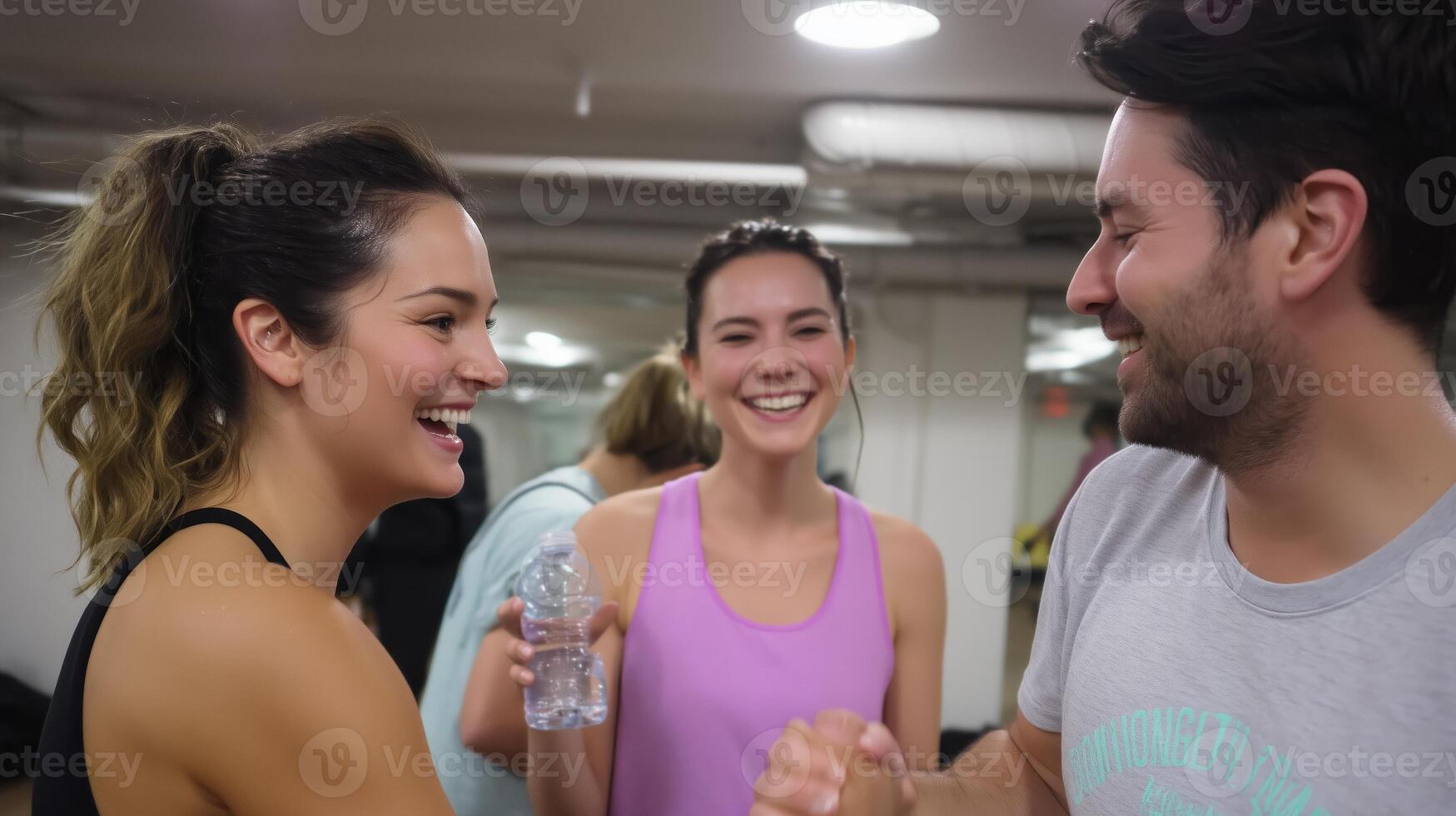 Friends share laughter and motivation during a workout session in a modern gym after an intense fitness class photo