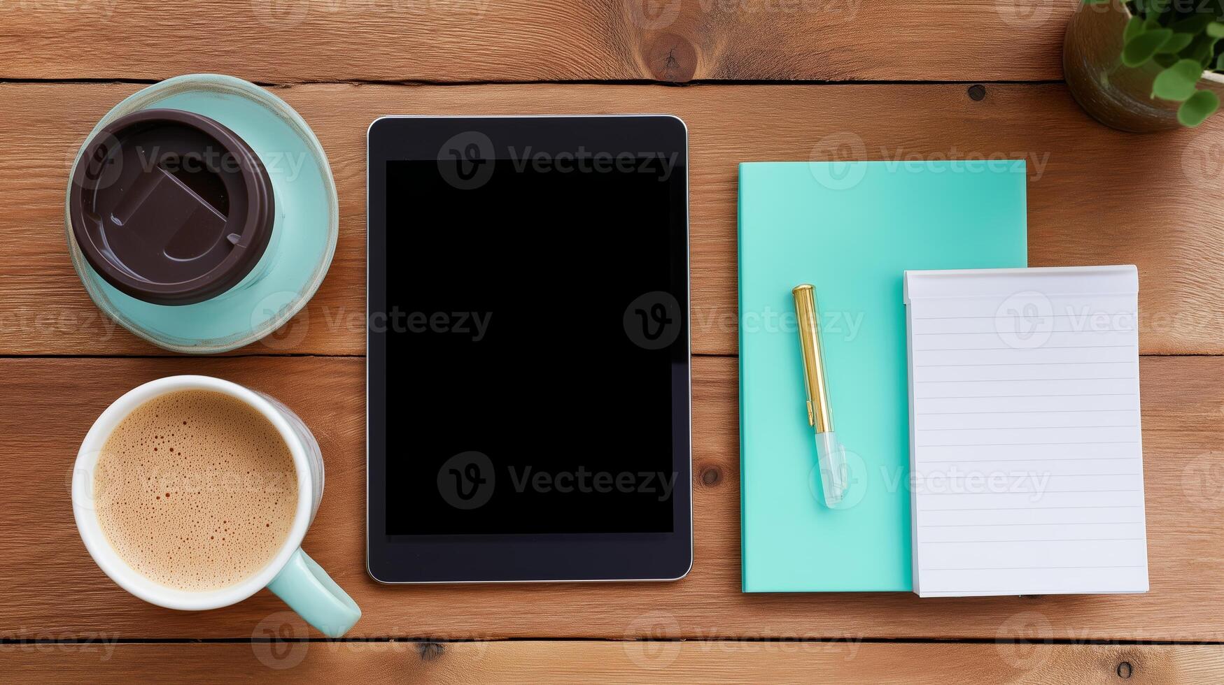 Workspace setup with coffee, tablet, and notepad for productivity and creativity photo