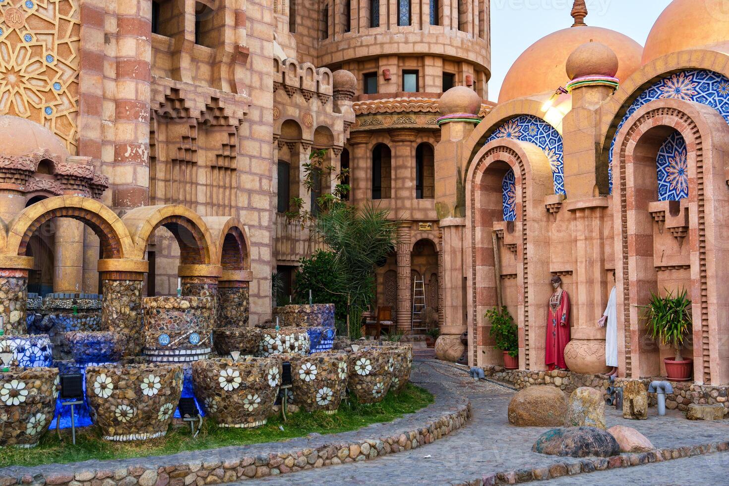Architecture showcases intricate designs in a historic courtyard featuring unique fountains and vibrant domes photo