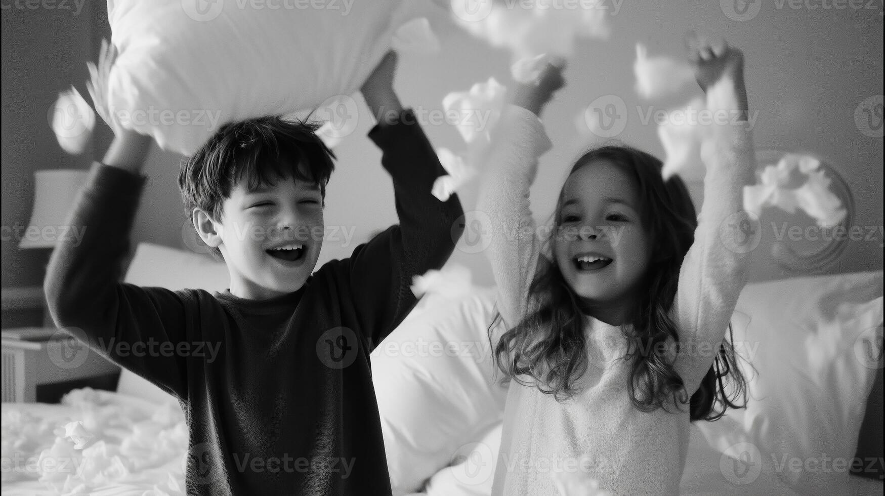 Siblings joyfully engage in a playful pillow fight in a cozy bedroom filled with soft feathers photo