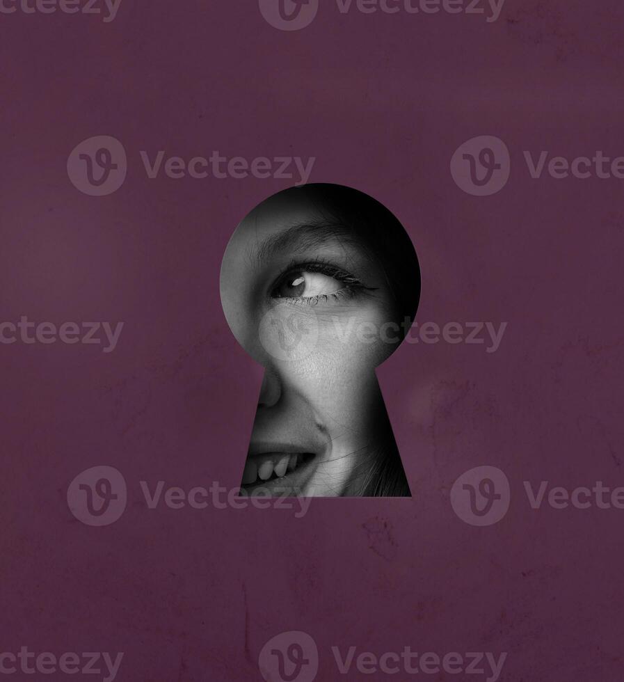 View through a keyhole reveals a smiling face, showcasing curiosity and intrigue in a vibrant setting photo