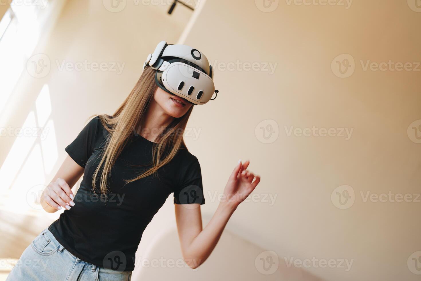 Young woman enjoys virtual reality experience in modern indoor space during afternoon hours photo