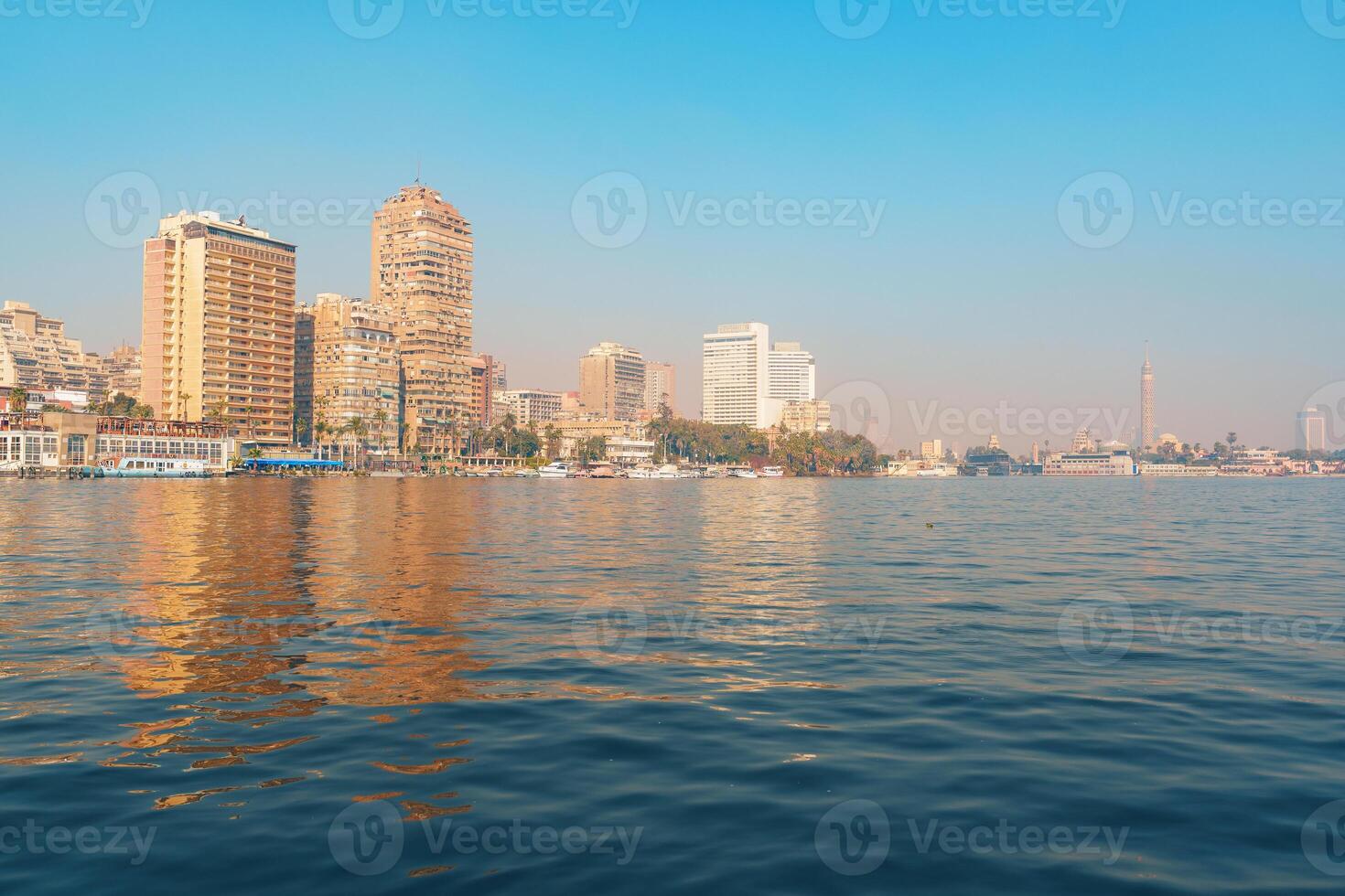 Cairo city skyline reflects on the Nile River during a clear day in the heart of Egypt photo