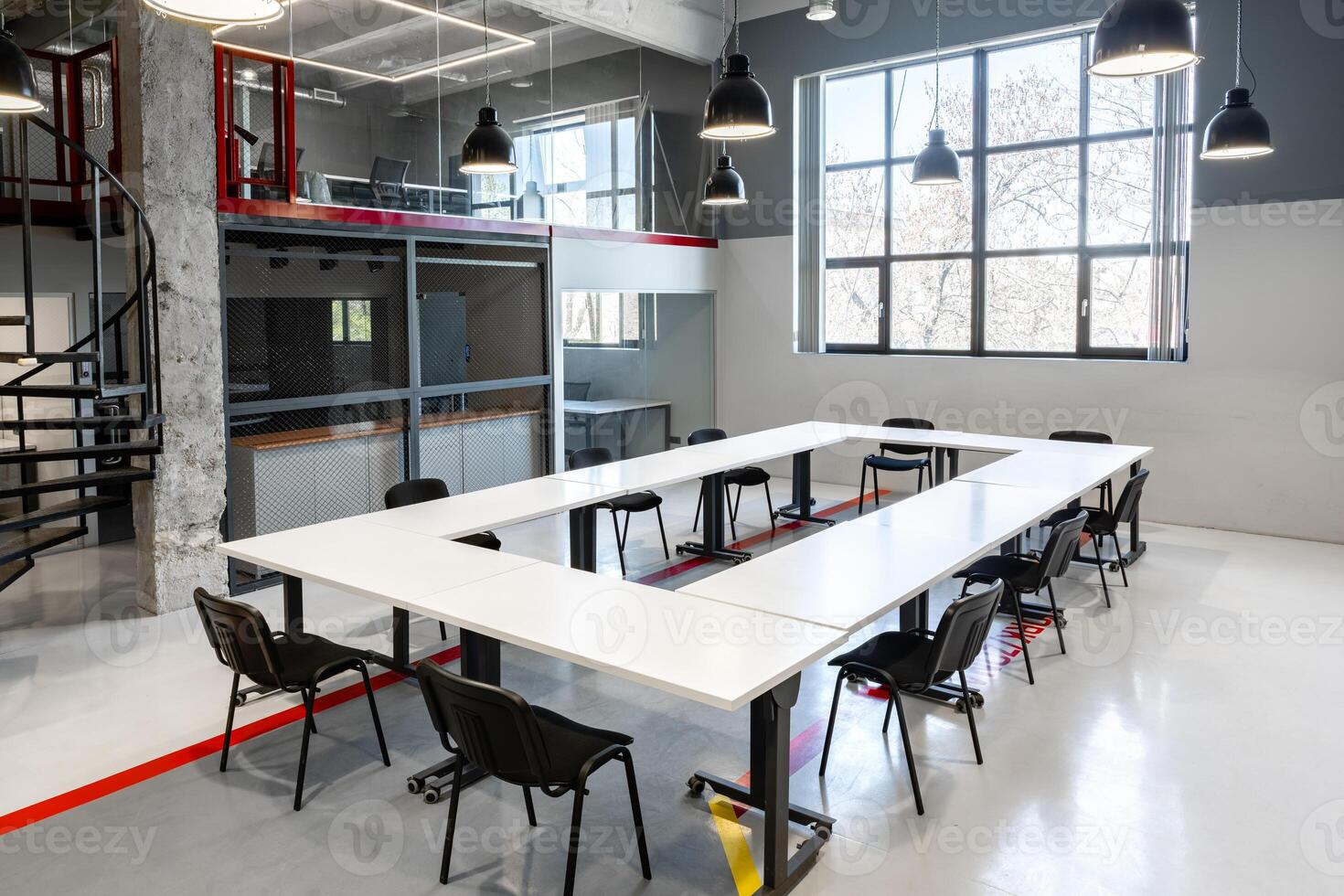 Modern coworking space designed for collaboration in an urban setting with ample natural light during daylight hours photo