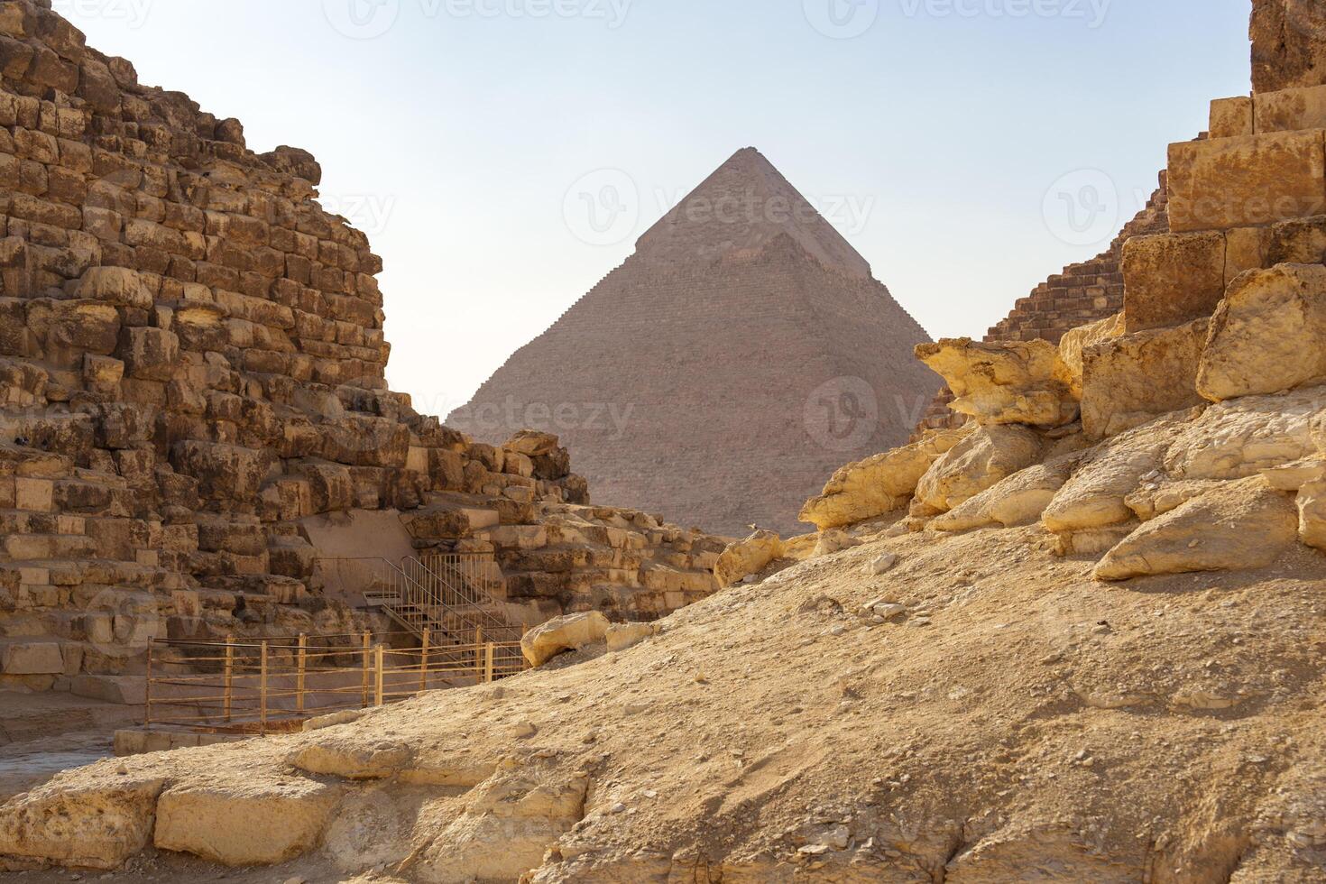 Exploring ancient pyramids at Giza, a glimpse of history amid golden sand under the bright sun photo